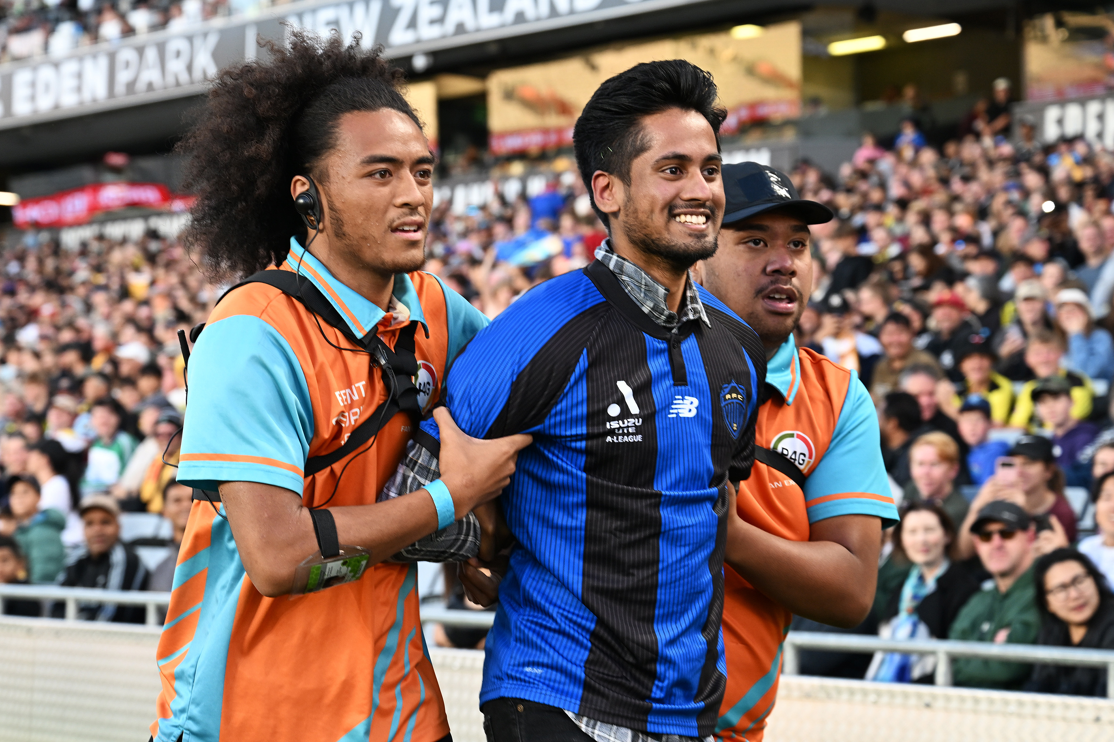Security removes a pitch invader in an Auckland FC shirt  - this is not a recommended avenue for showing support. Photo / Photosport