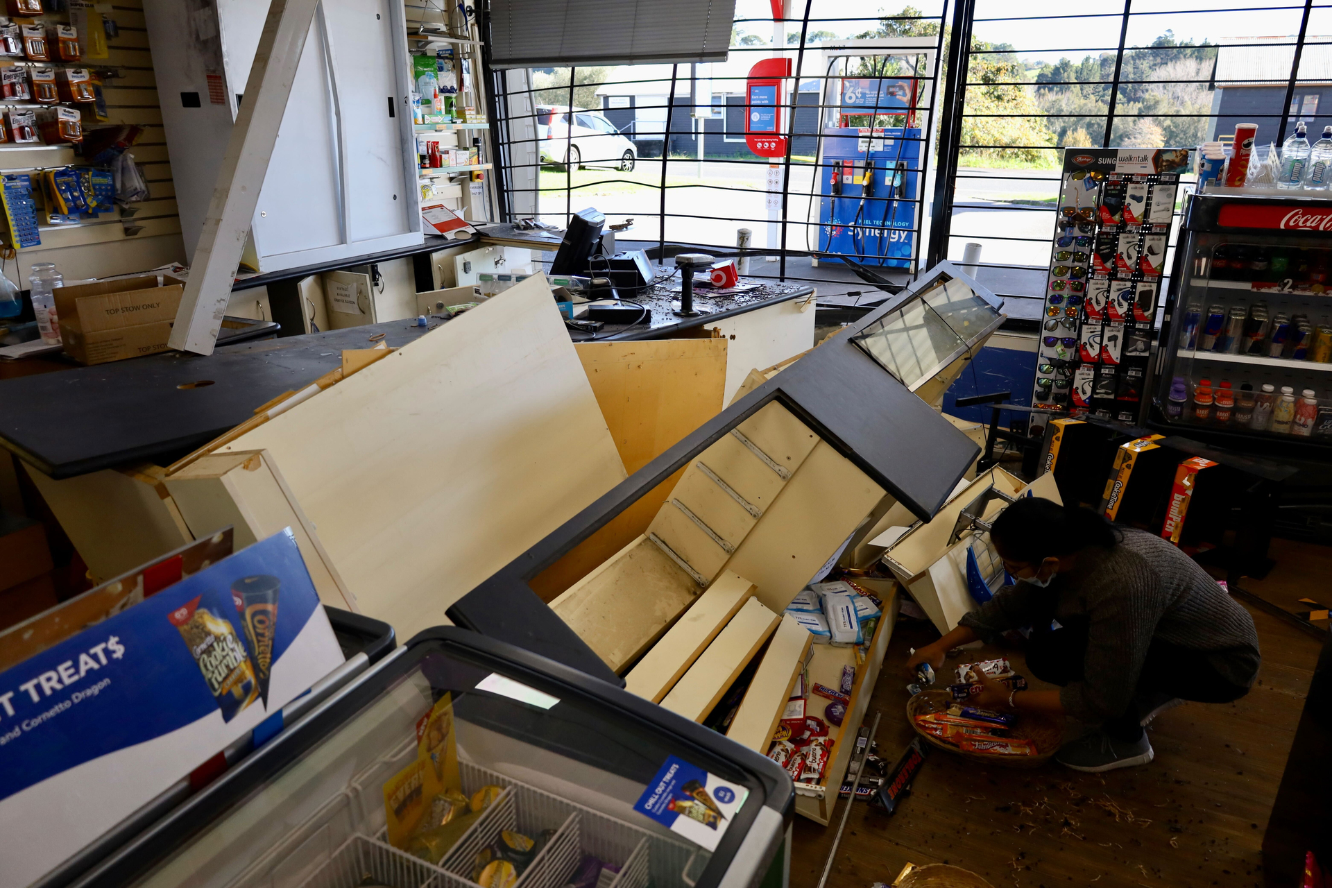 Staff at Mobil Oratia in Auckland clean up after the store was ram-raided last week. Photo / Jed Bradley