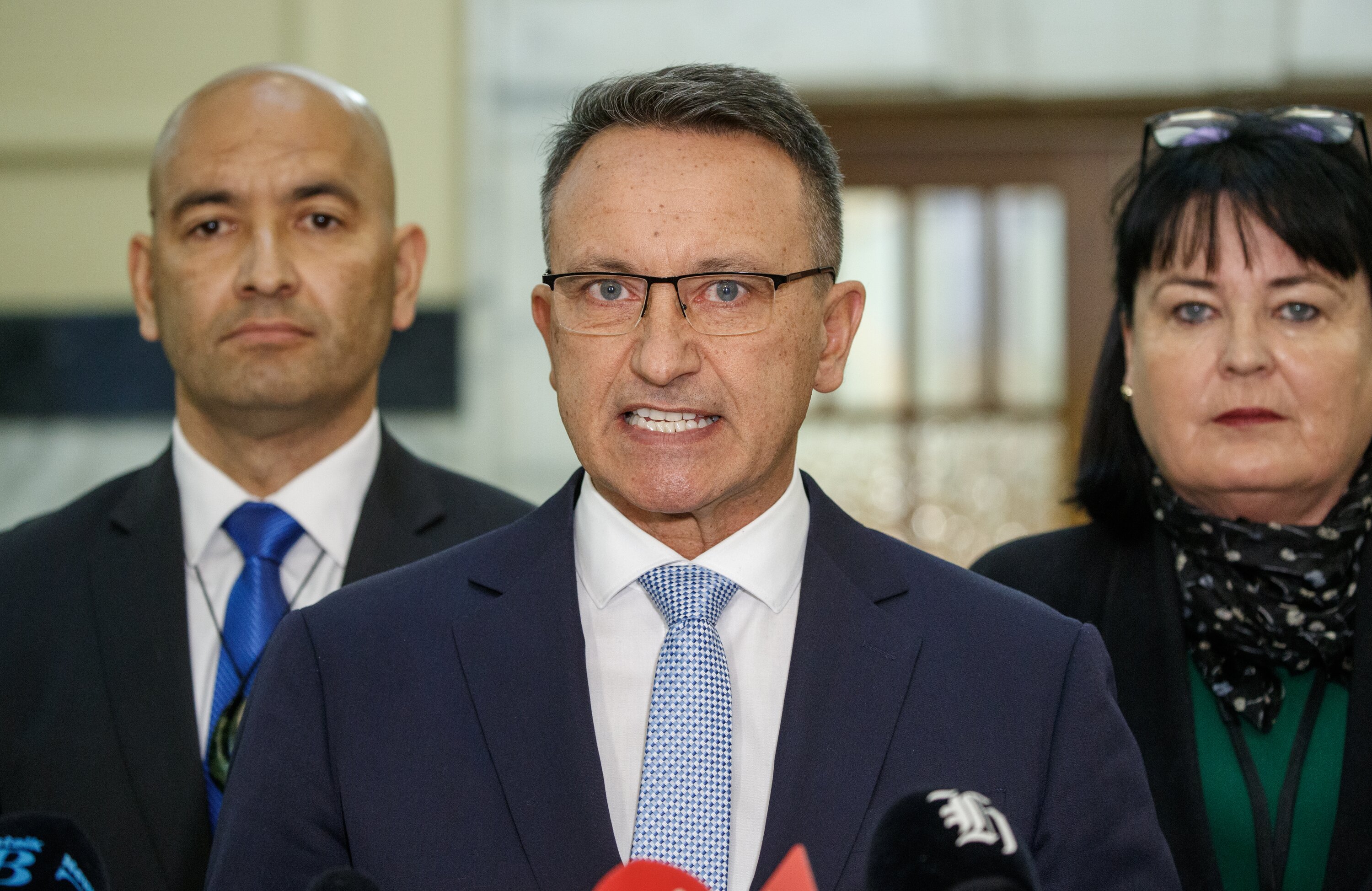 National MP for New Plymouth David MacLeod (centre), flanked by colleagues Tama Potaka (left) and Dana Kirkpatrick, explaining himself to media after it was discovered he had not declared most of his campaign donations. Photo / Mark Mitchell