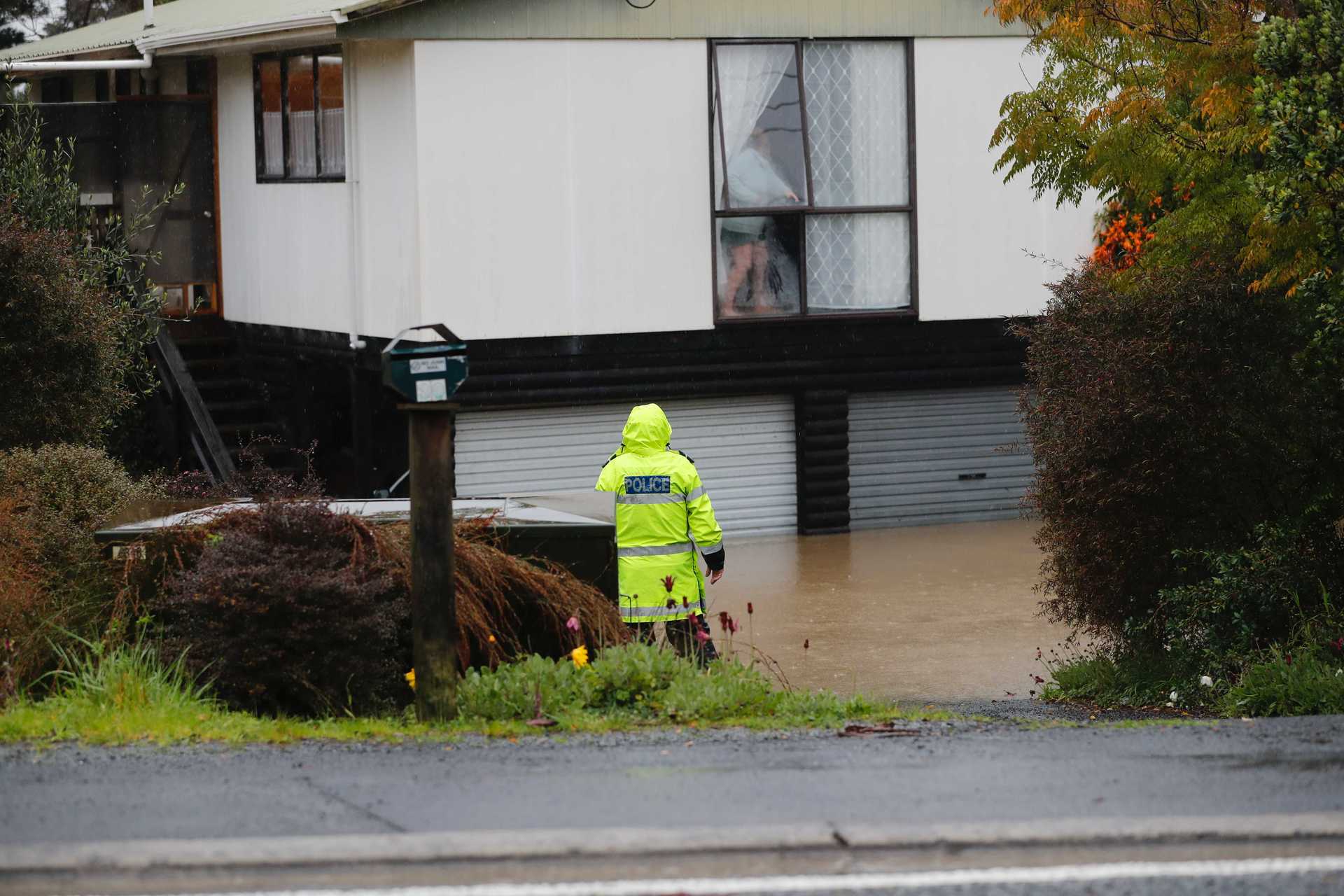 Police are making checks on residents on Oraha Road in Kumeu. Photo / Dean Purcell.