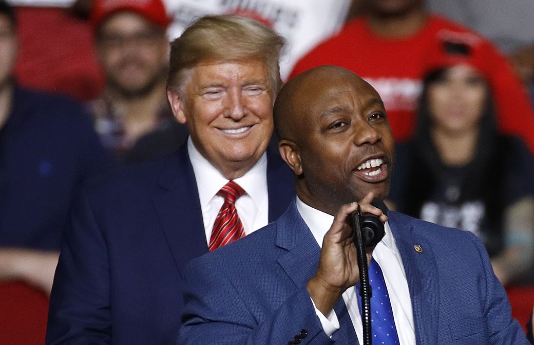 Senator Tim Scott speaks in front of President Donald Trump during a campaign rally. Photo / AP