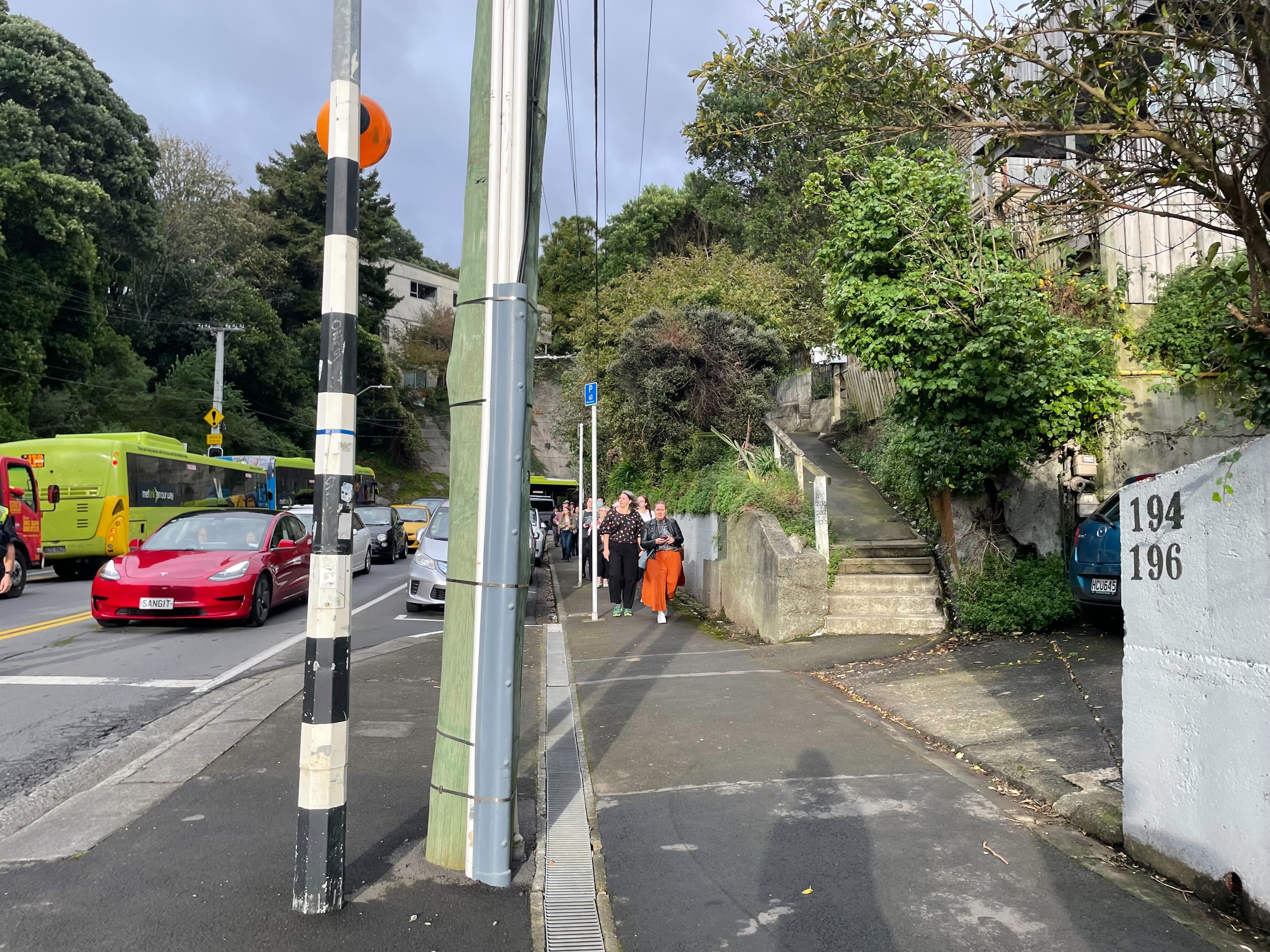 Commuters decide to walk after Restore Passenger Rail protesters blocked Glenmore Street in Karori. Photo / Azaria Howell