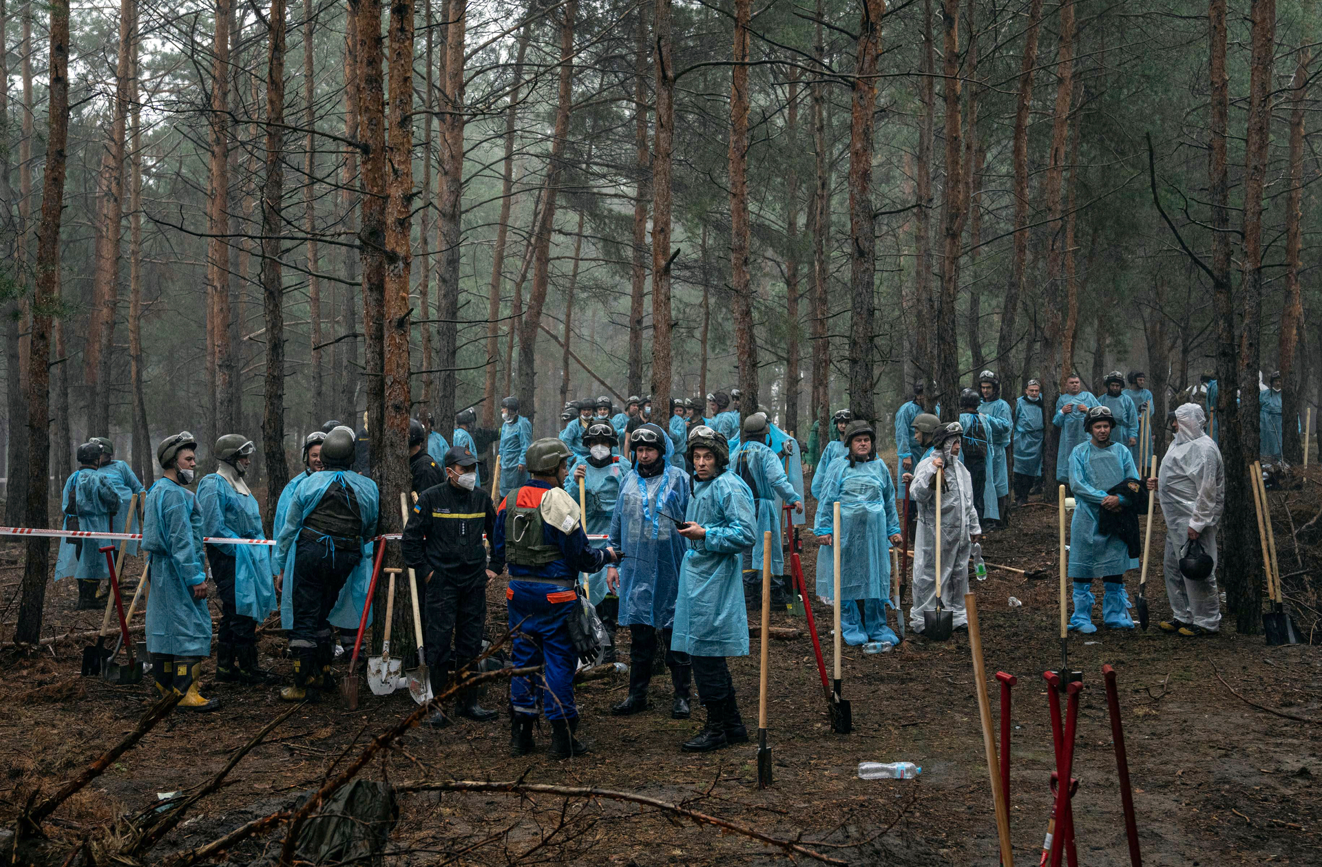 Emergency workers have a rest during the exhumation in the recently retaken area of Izium, Ukraine on Friday. Photo / AP