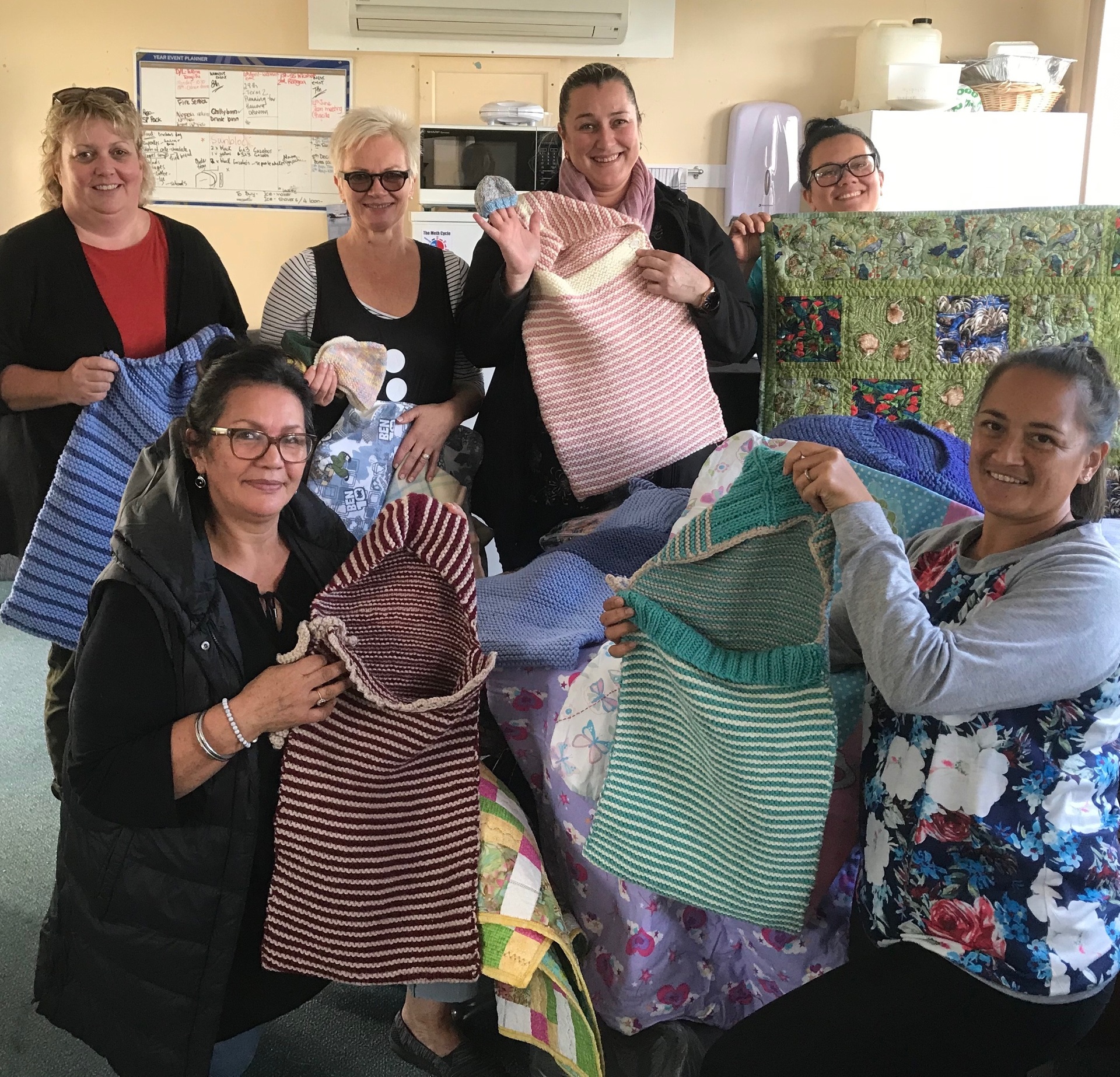Social workers at Hokianga Health unpack Angel Sacks and blankets.
