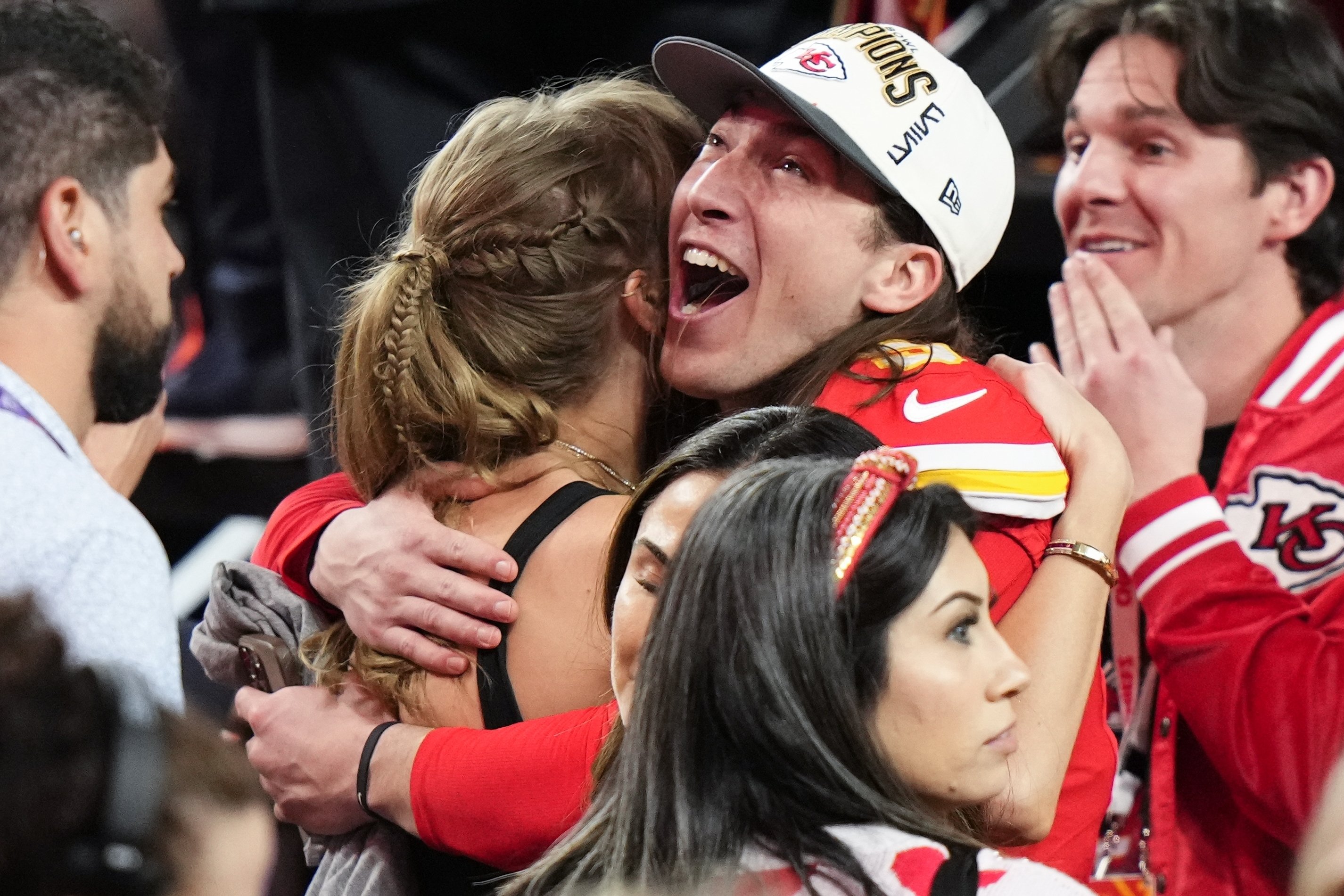 Kansas City Chiefs kicker Harrison Butker embraces Taylor Swift after the win. Photo / AP