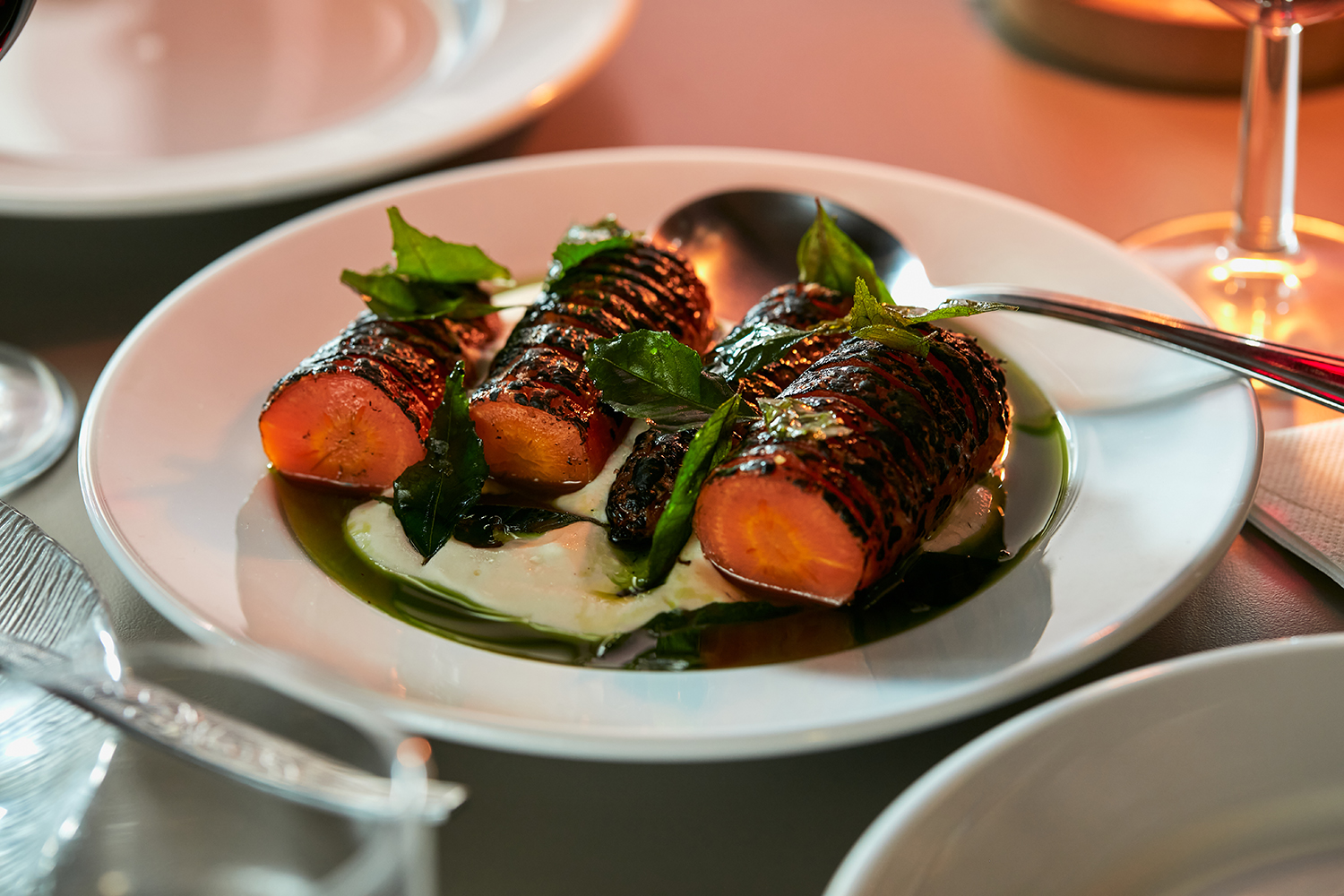 The Hasselback carrots served with smoky yoghurt and crisped curry leaves. Photo / Babiche Martens