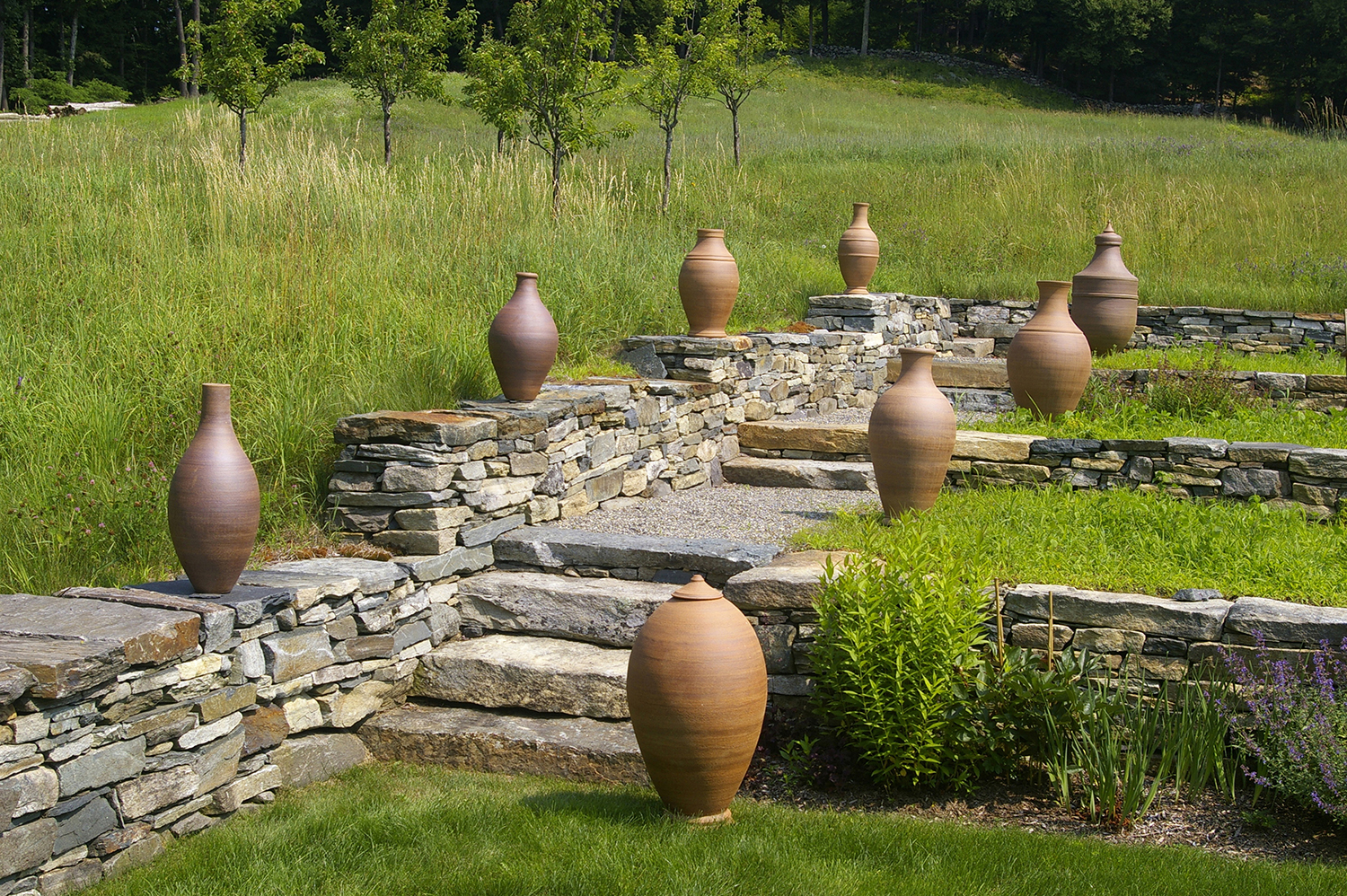 A collection of Stephen Procter’s stoneware pots flank a stone staircase at a private home in Guilford. Photo / Stephen Procter via The New York Times