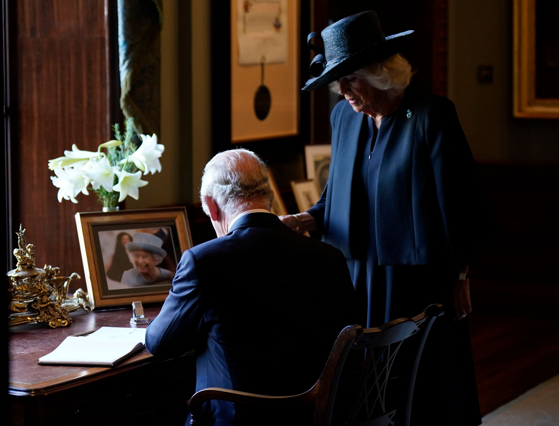 Crowds cheer as King Charles III and Camilla, the Queen Consort sign the visitors book during a visit to Hillsborough Castle, Belfast. Photo / AP