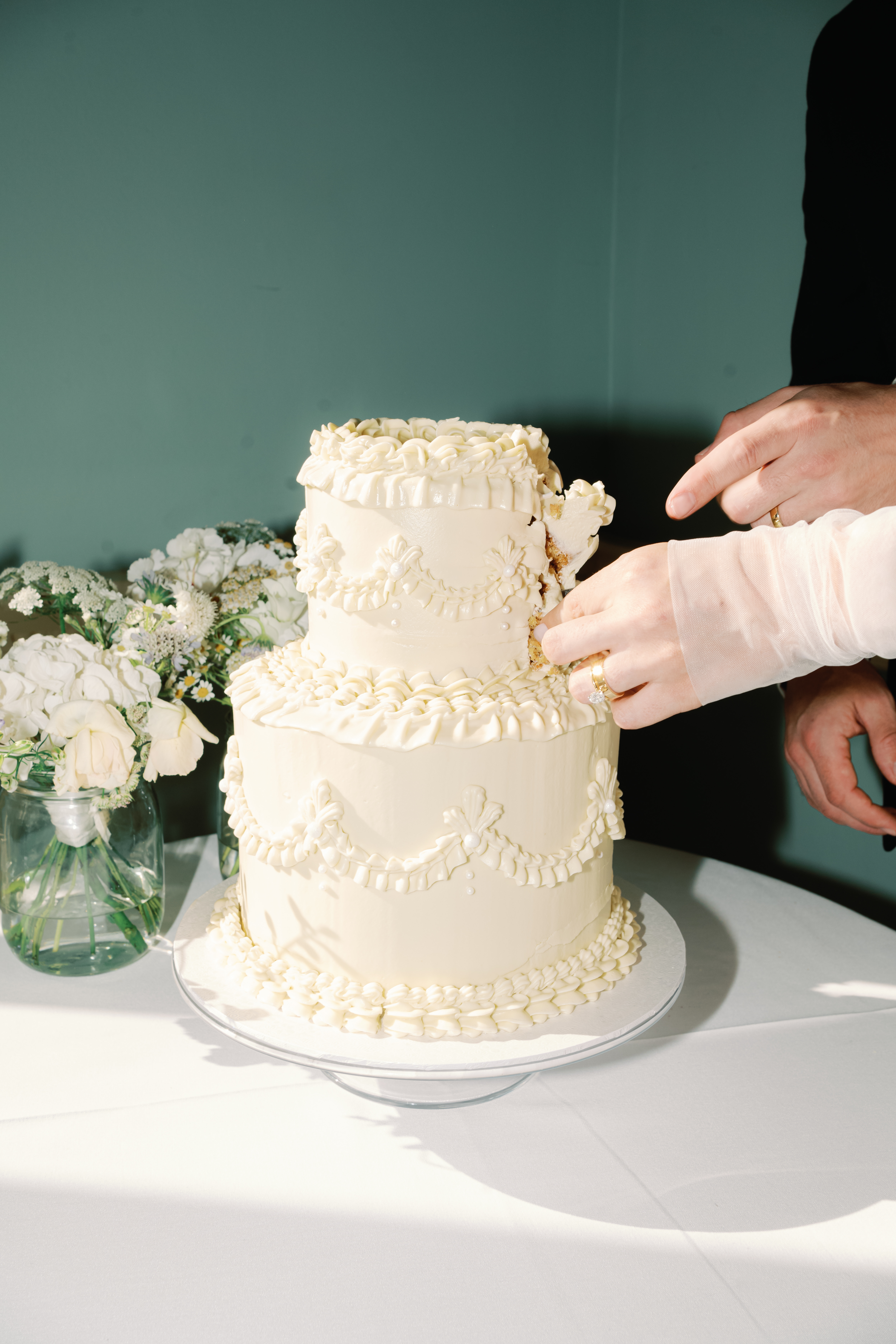 Yiselle and Christopher’s wedding cake was designed by Hebe Konditori. Photo / Jessica Lily