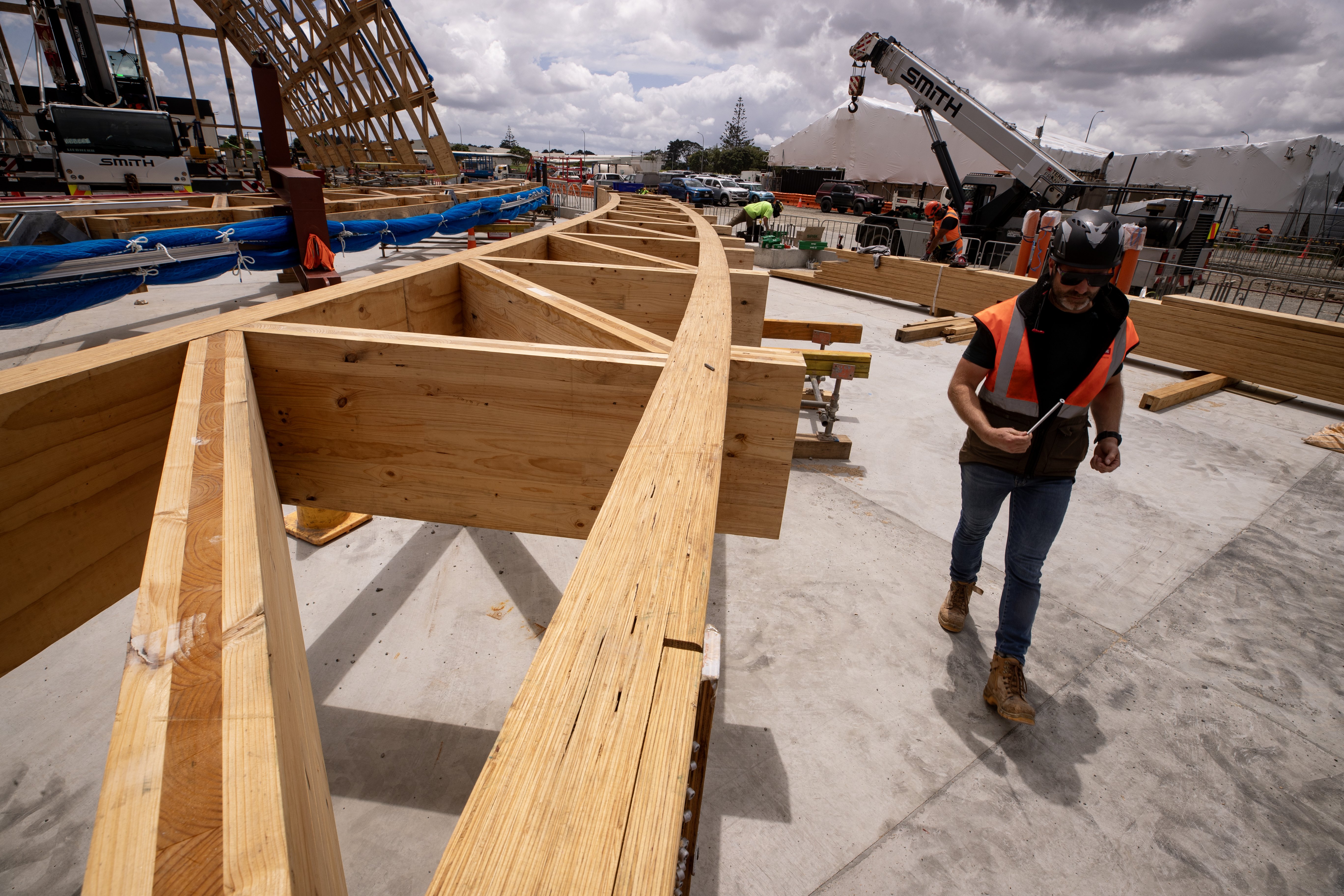 NZ Strong pre-construction and innovation manager Jimmy Corric near one of Hangar 4's wooden trusses. Photo / Dean Purcell