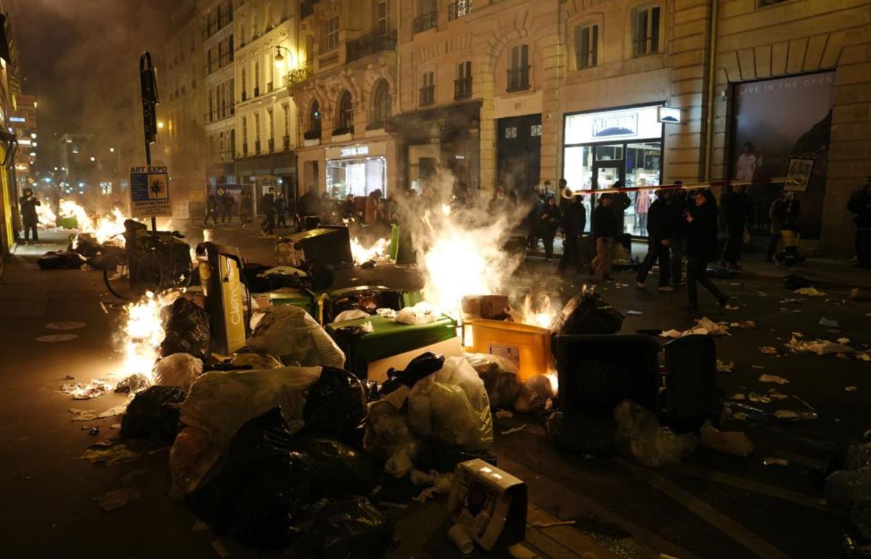 Garbage is set on fire by protesters after a demonstration near Concorde square, in Paris. Photo / AP