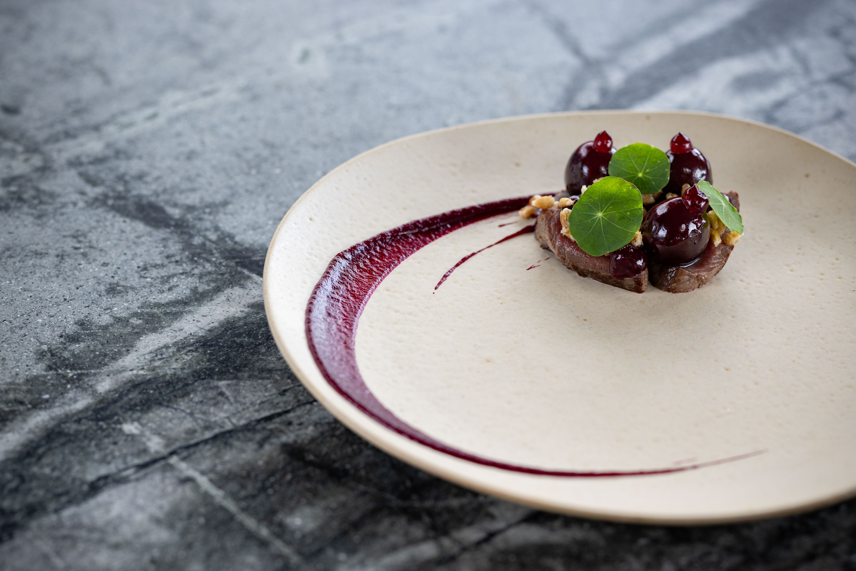Venison with beetroot and cherries. Photo / Babiche Martens