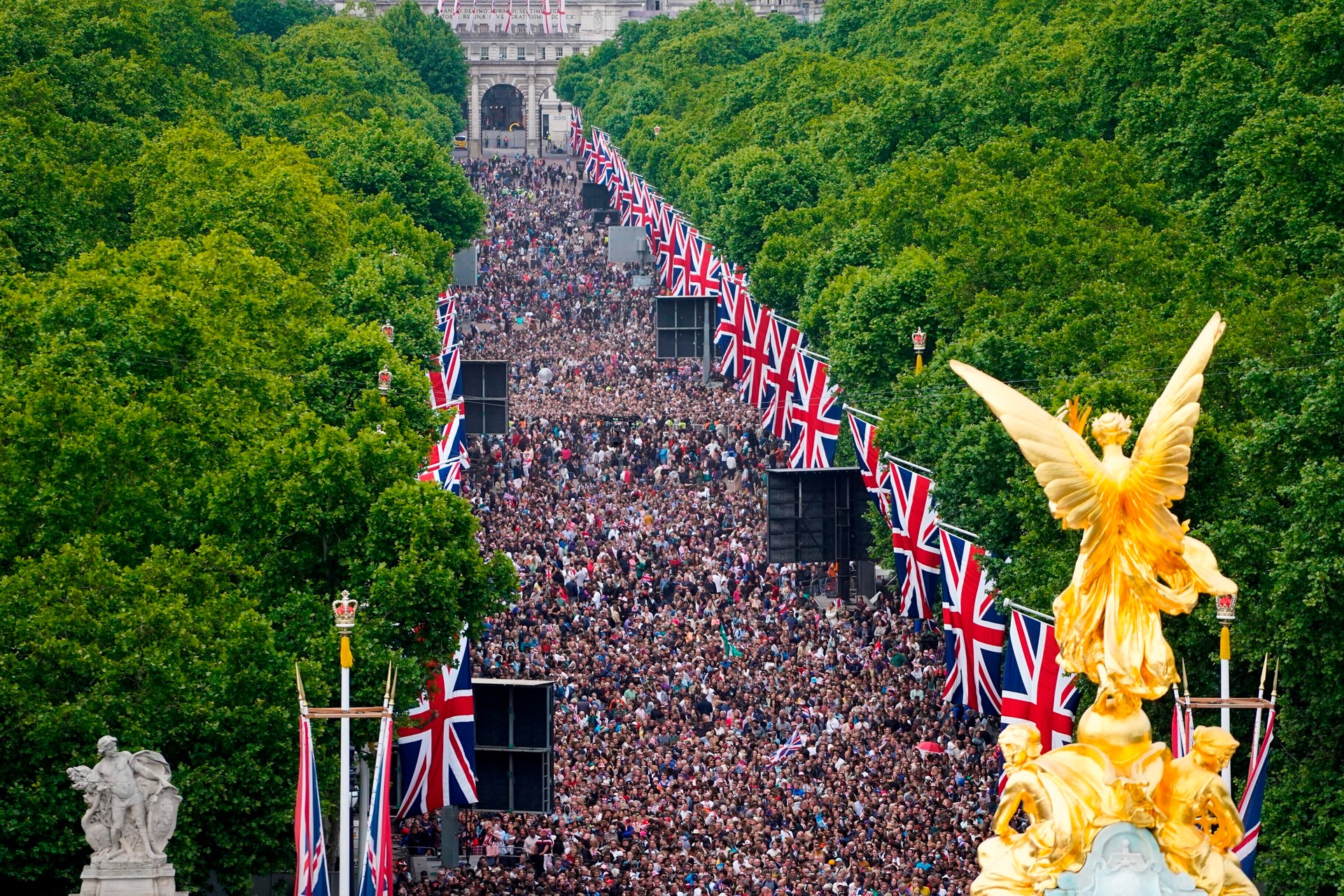 Crowds on the Mall watch the Platinum Jubilee concert, taking place in front of Buckingham Palace in London. Photo / AP