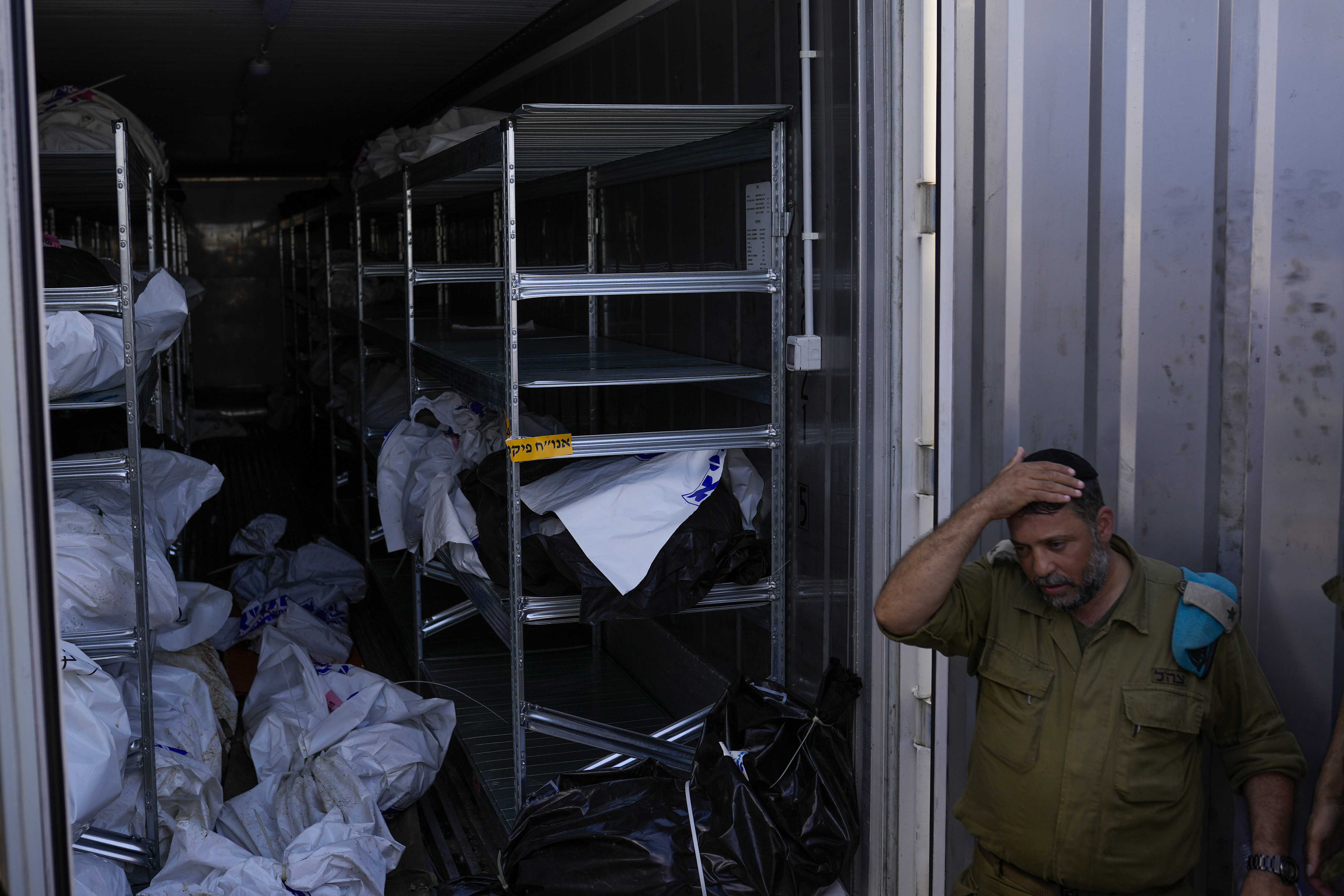 The bodies of Israelis killed in an unprecedented Hamas attack are gathered for identification at a military base in Ramla, Israel. (AP Photo/Francisco Seco)