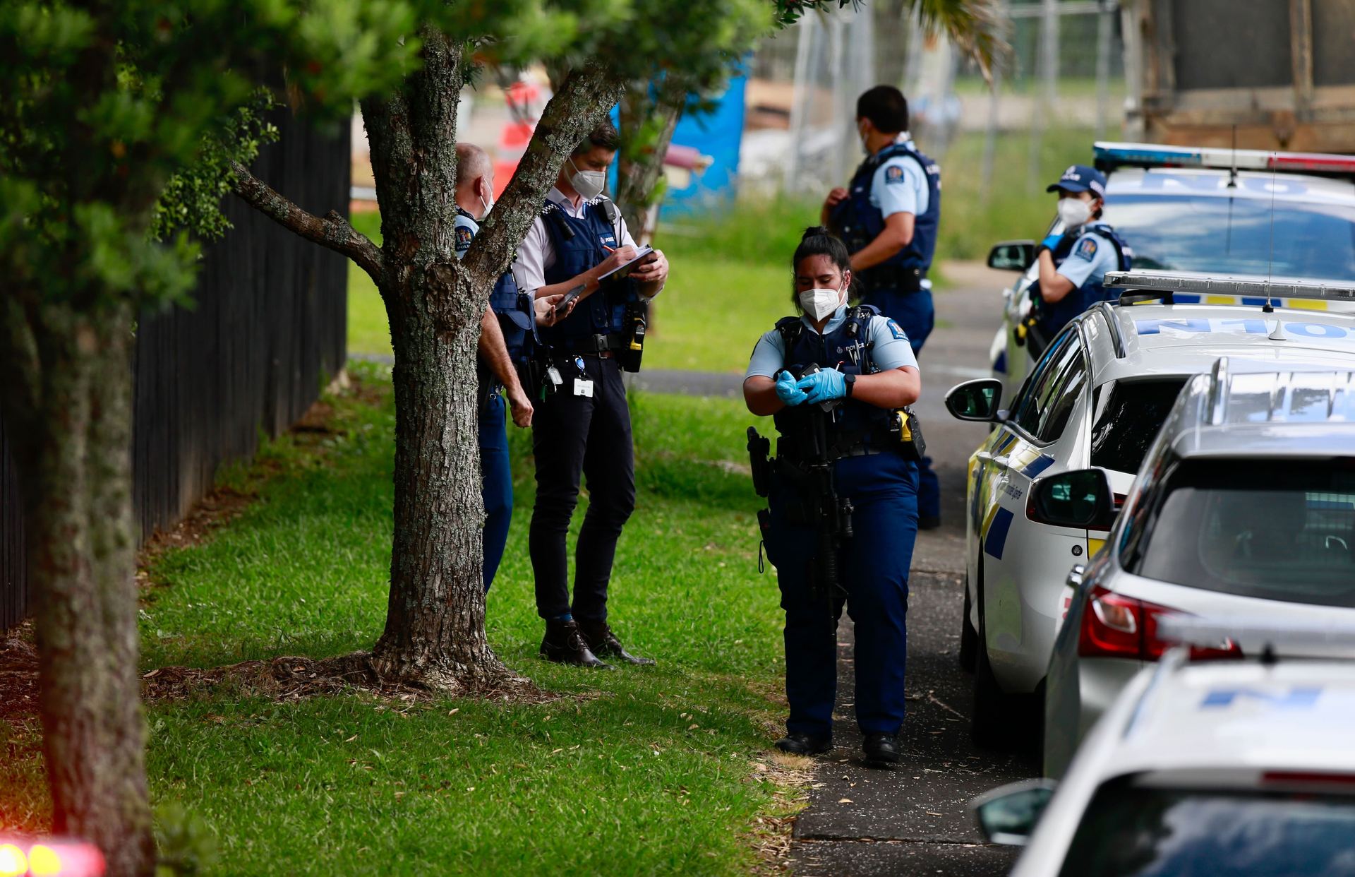 Police officers at the scene in Glen Eden. Photo / Alex Burton
