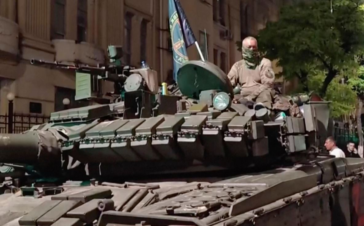 A man sits atop an armoured vehicle in the street as residents of the southern Russian city of Rostov-on-Don talk with military personnel. Photo / AP