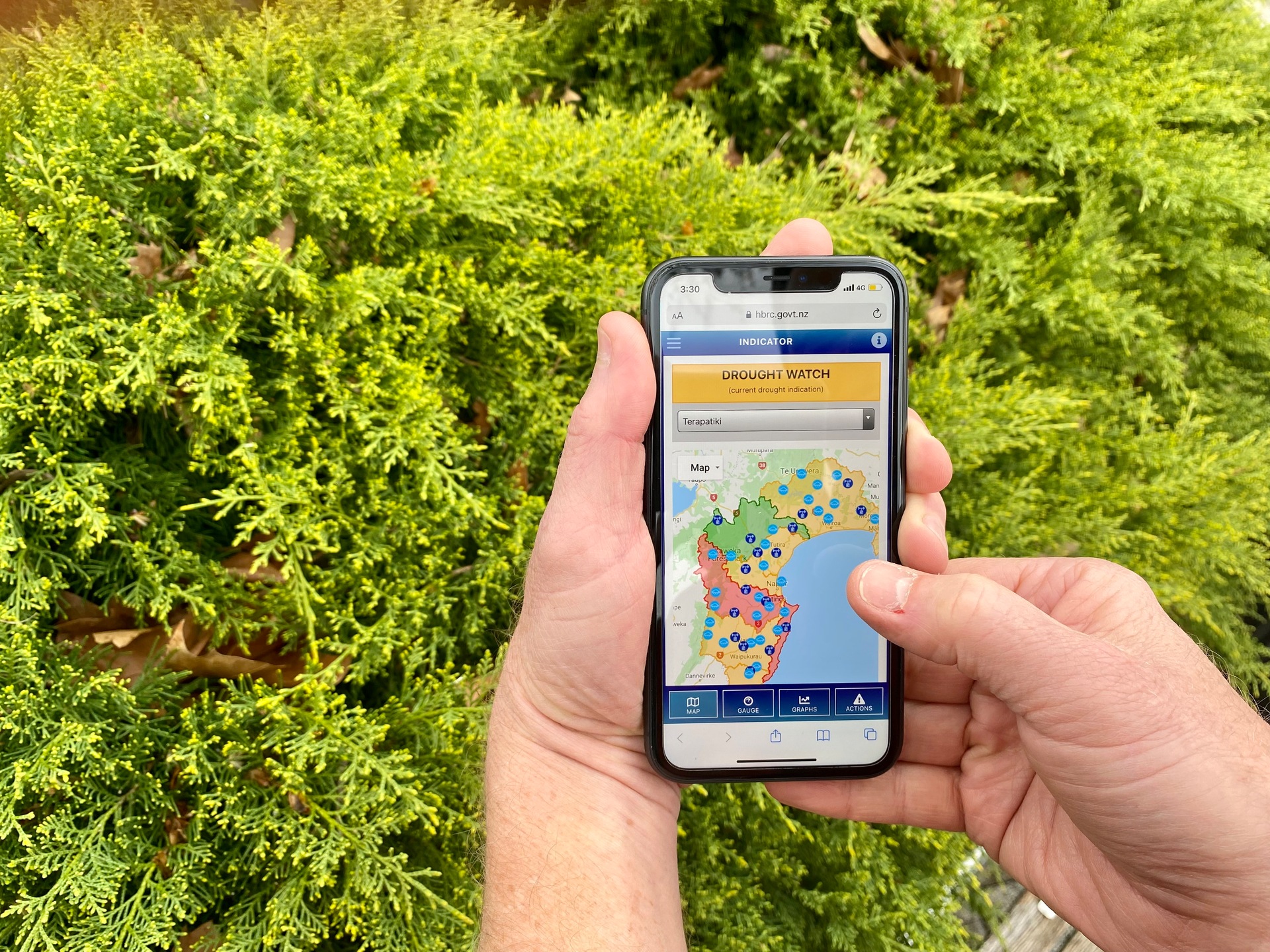 At thumbtip and fingertips, the new drought indicator app at work on the farm. Photo / Supplied