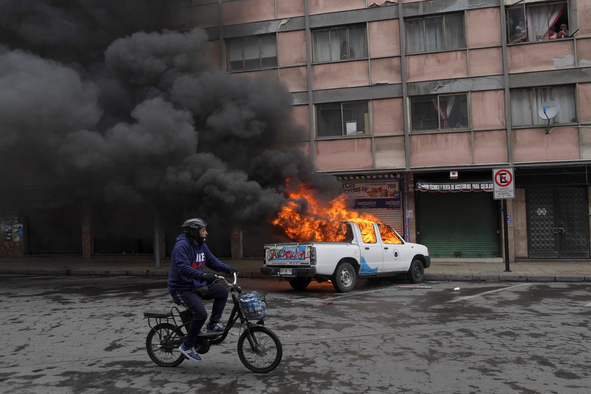 A city government ute set alight last Sunday in a march marking the 49th anniversary of a right-wing coup that toppled President Salvador Allende in Santiago, Chile. Photo / AP