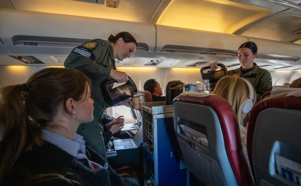 Defence staff in uniform manage the trolley service. Photo: RNZ / Nate McKinnon