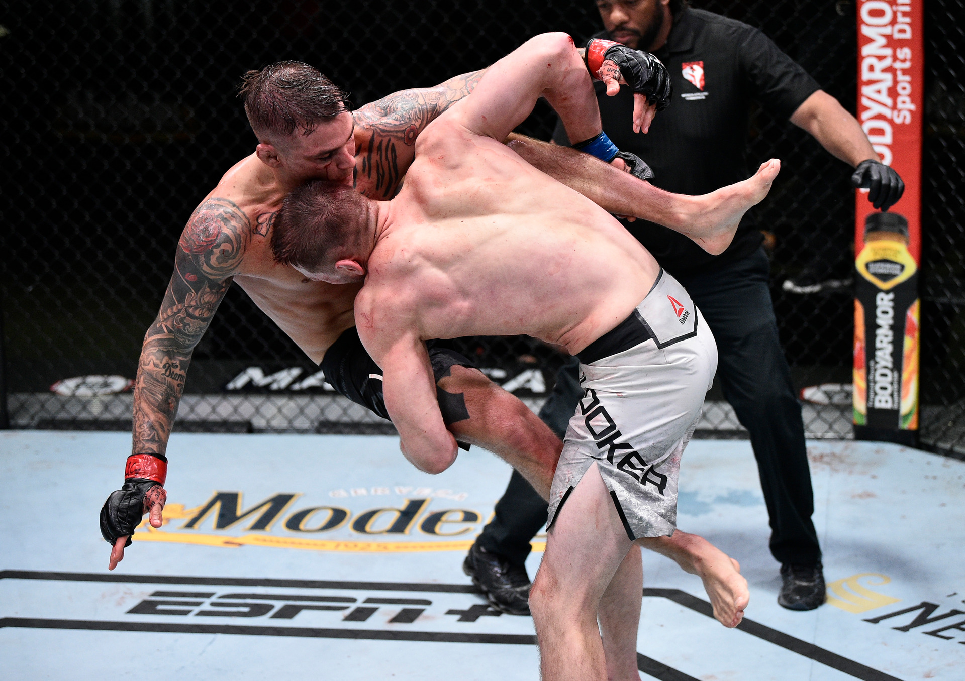 Dan Hooker takes Dustin Poirier down. Photo / Getty Images