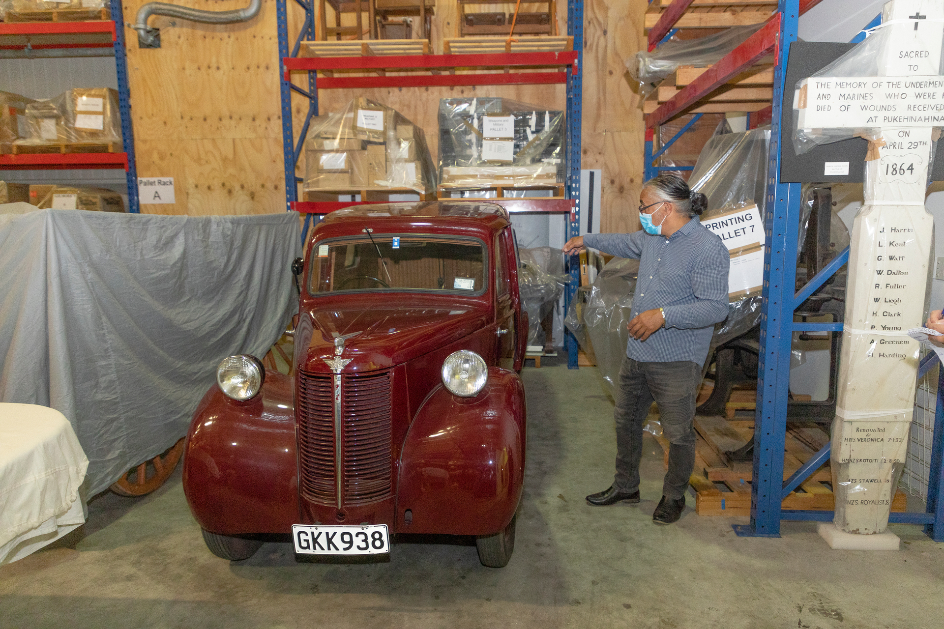 A 1949 Austin sits in storage as part of the Tauranga Heritage Collection, with Maori cultural and heritage manager Dean Flavell alongside. Photo / Andrew Warner  
