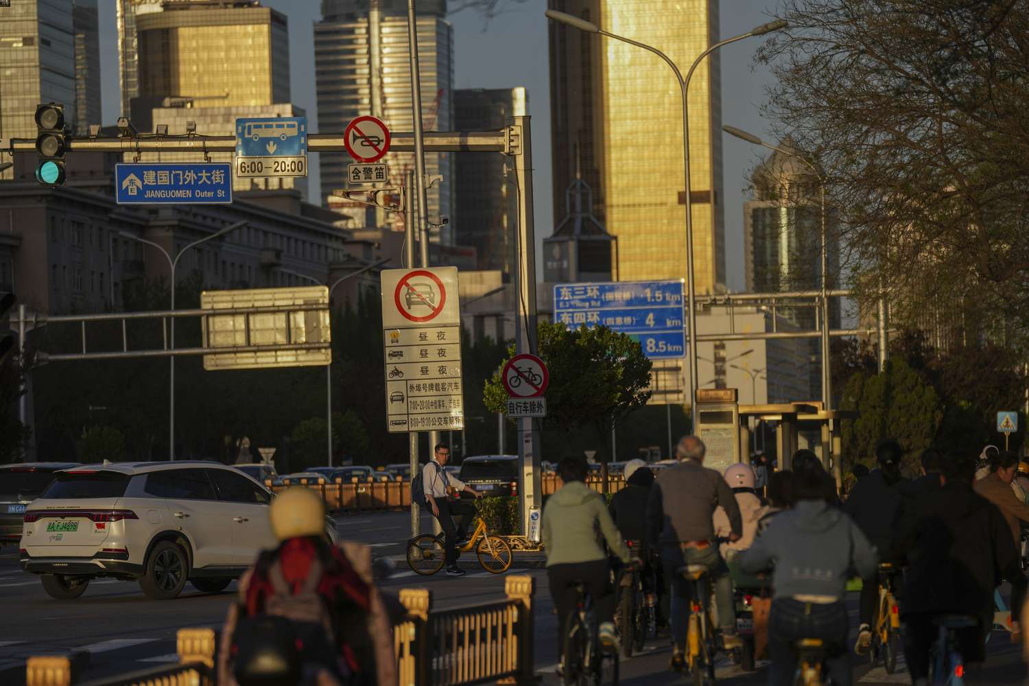 A cyclist waits at a traffic light during the evening rush hour at the main business district in Beijing. China is by far our most important trading partner. Photo / AP