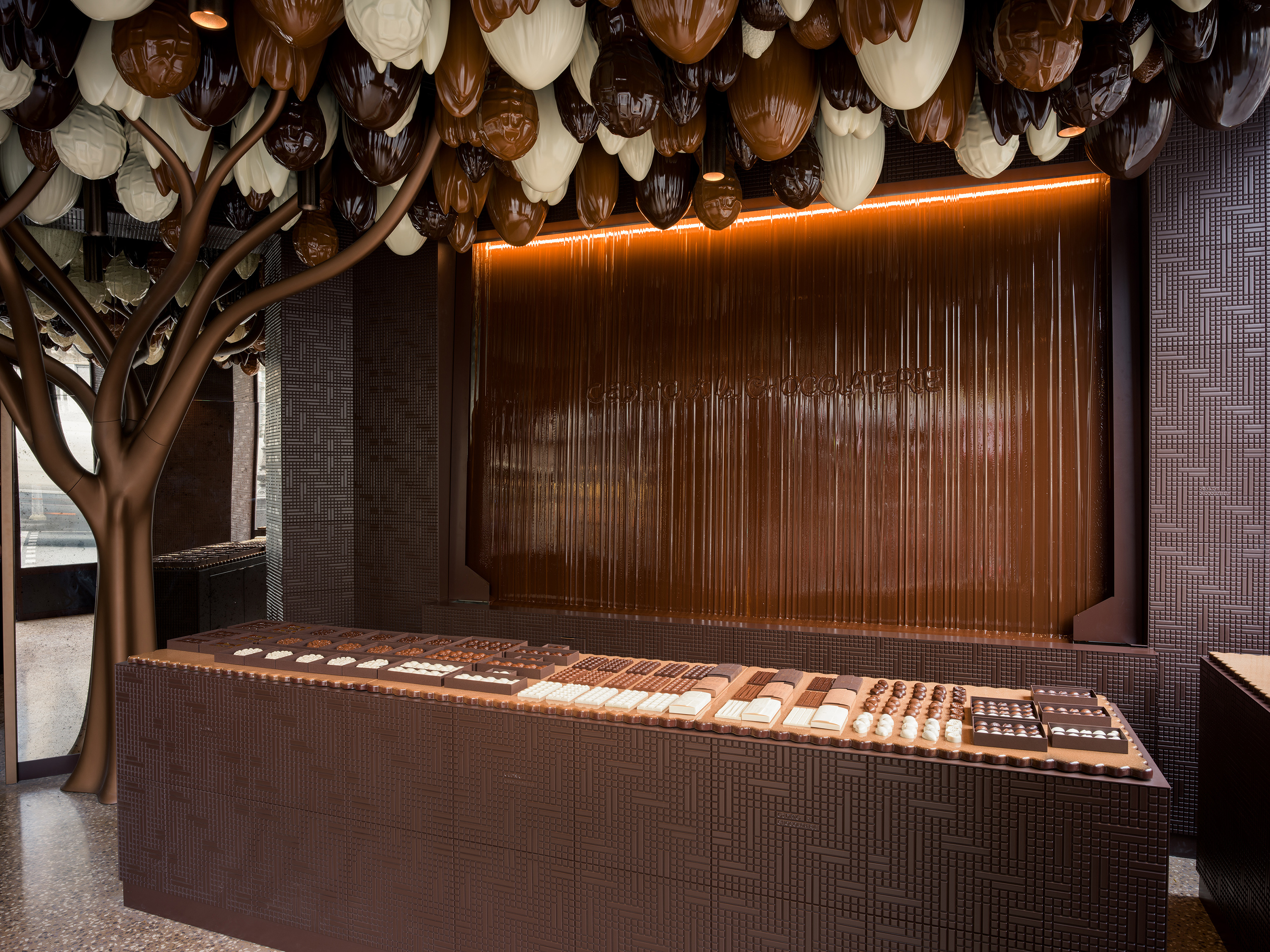 A wall of melted chocolate is the centrepiece of Cedric Grolet’s new chocolate boutique. Photo / Matthew Avignone, The New York Times