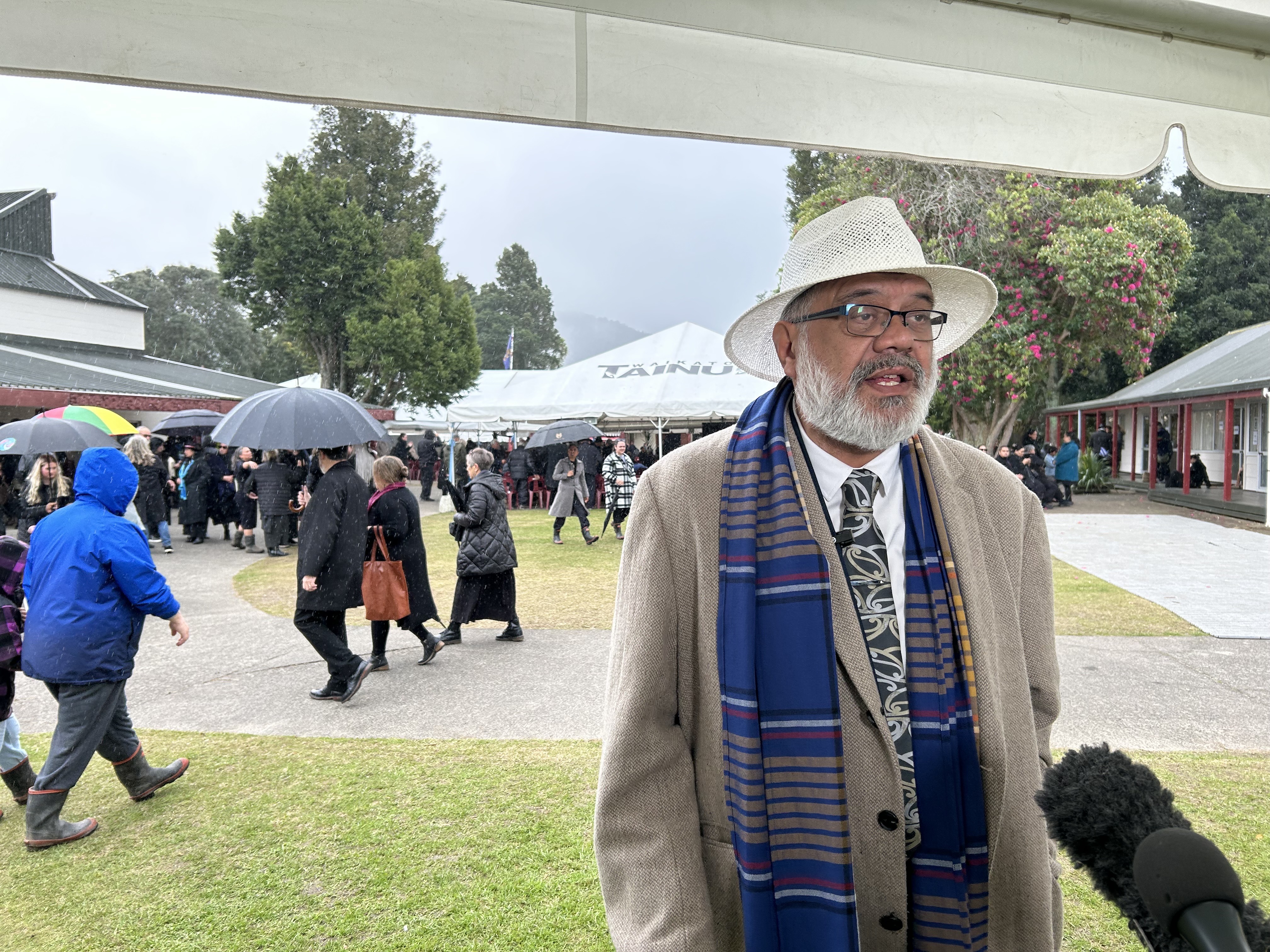 Kīngitanga spokesman Rahui Papa speaks to media as the rain falls at Tūrangawaewae Marae. Photo / Adam Pearse