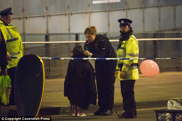 Police reassure children traumatised by an explosion at the Manchester Arena. Photo / Cavendish Press
