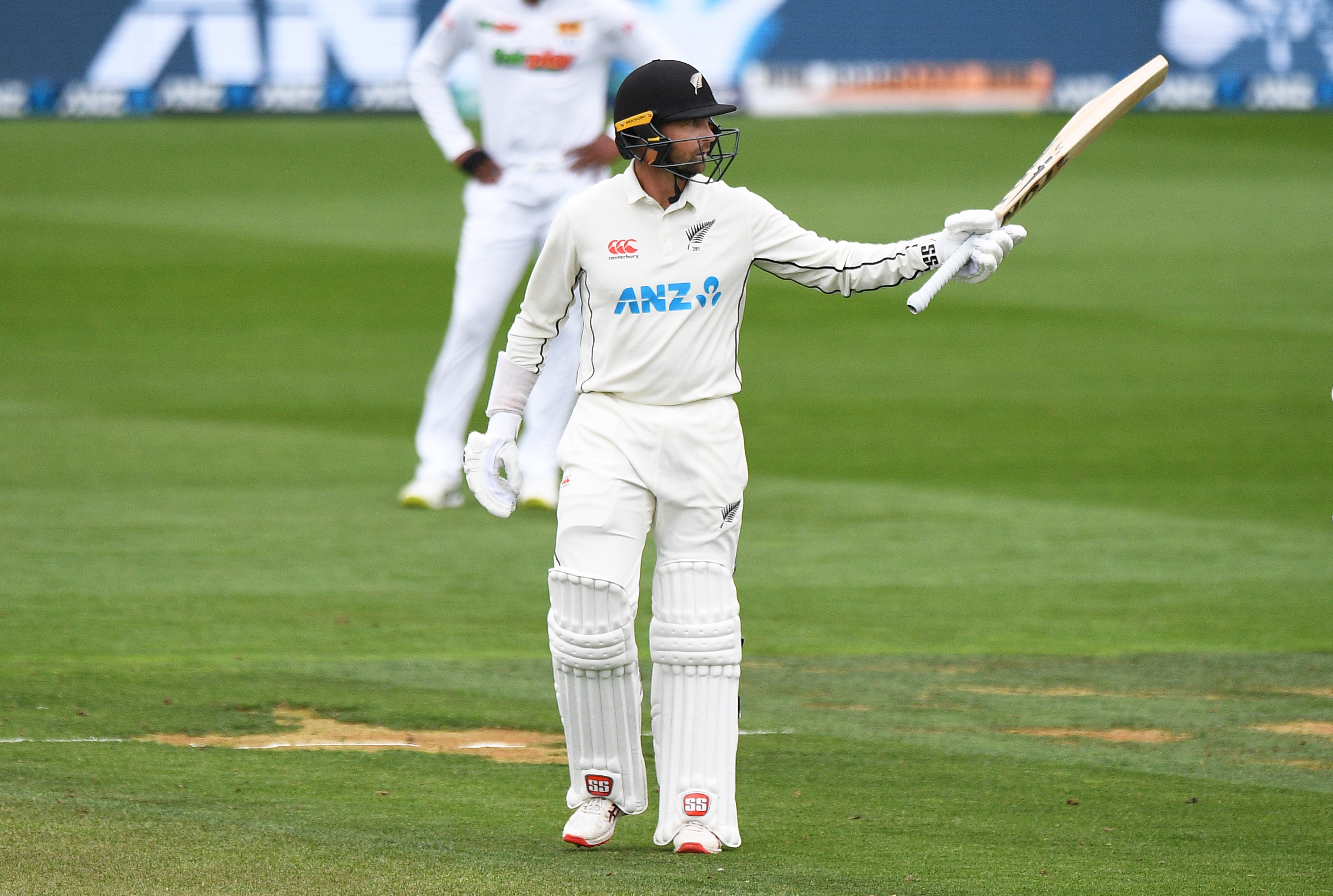 Devon Conway raises his bat after reaching his half-century. Photo / Photosport