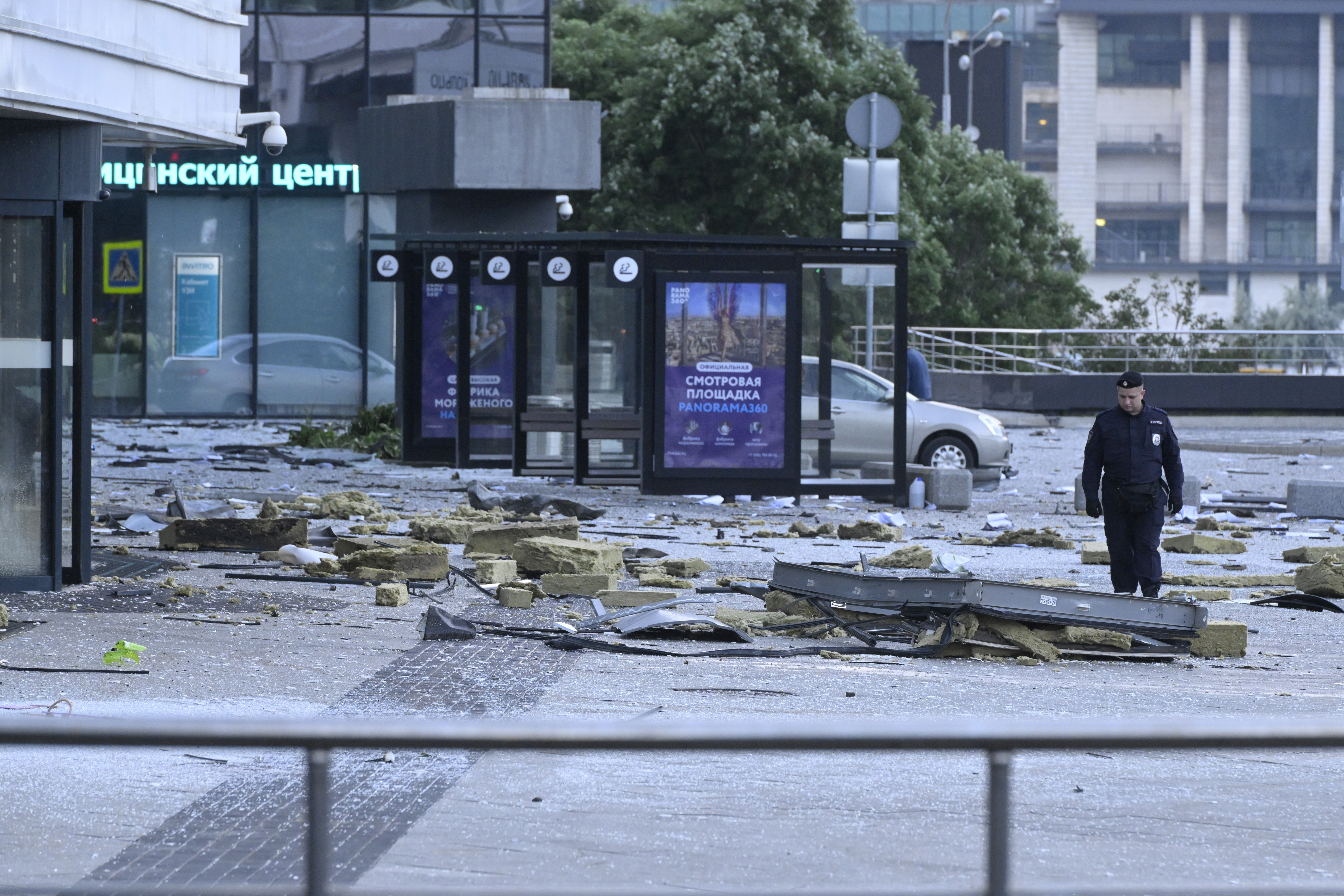 A Russian investigator examines an area next to a damaged skyscraper in Moscow. Photo / AP