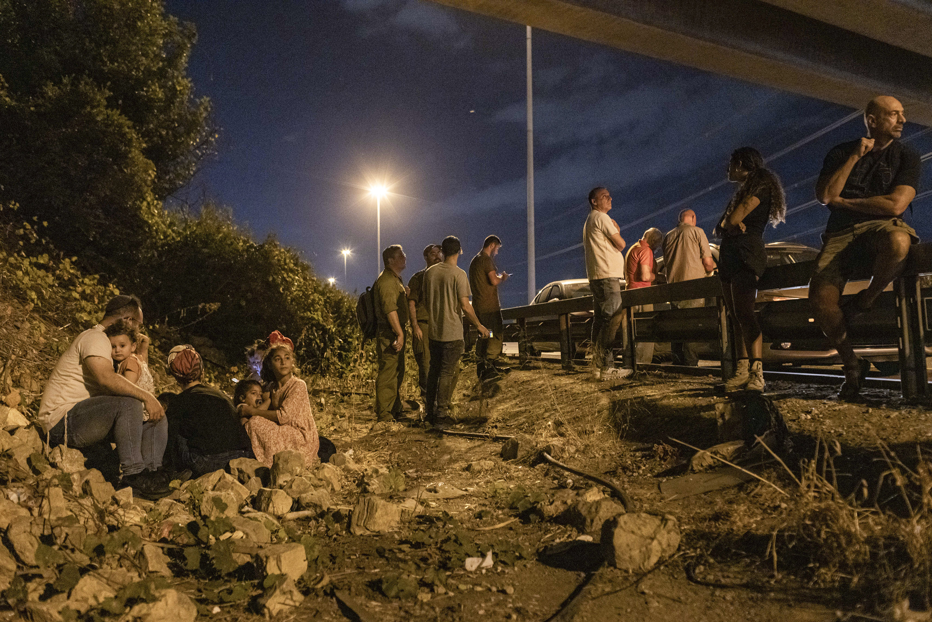 Taking cover on the side of the road near Kfar Saba, Israel, as a siren warned of incoming missiles. Photo / Avishag Shaar-Yashuv, The New York Times