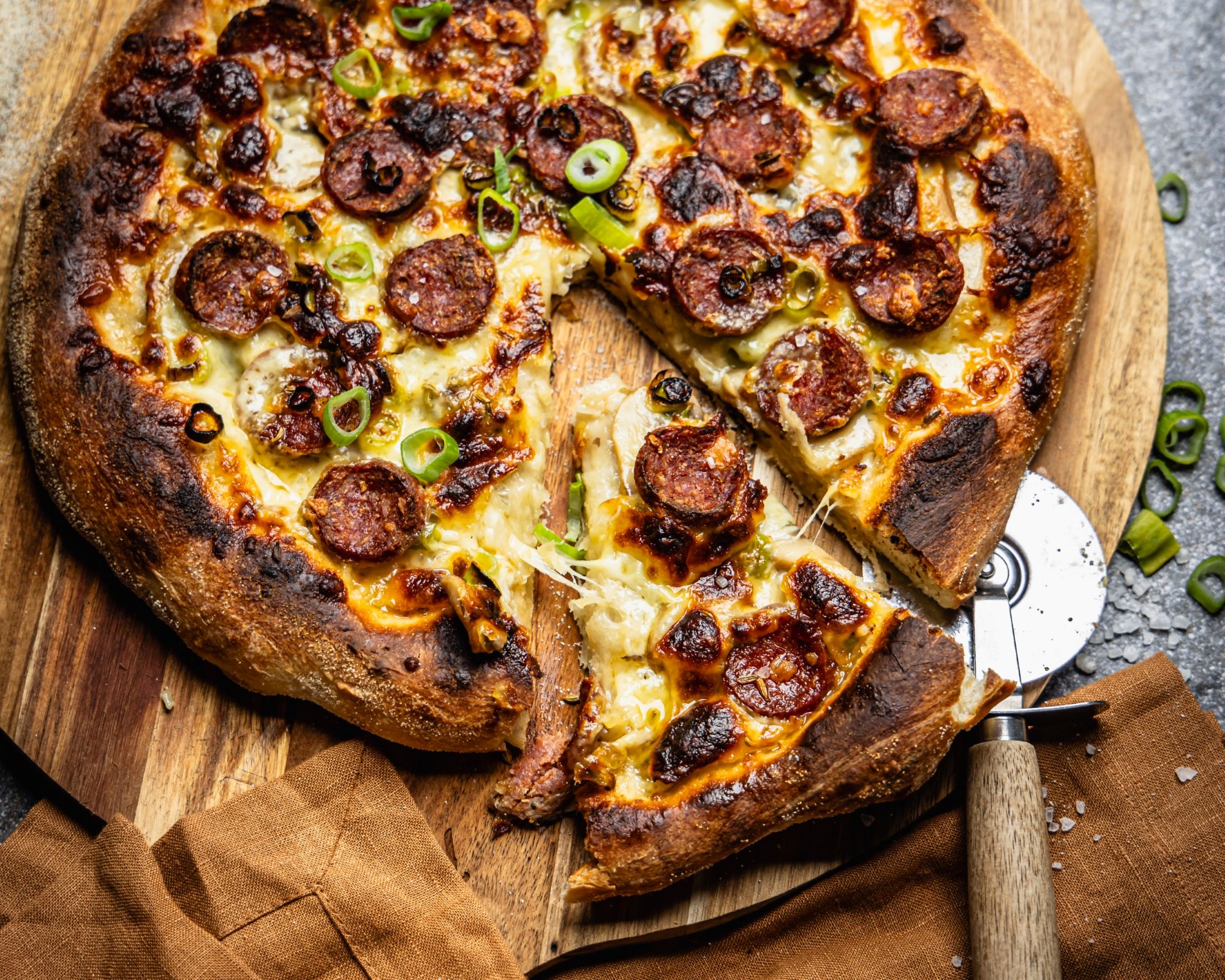 Recipe: Kransky, mushroom and spring onion white pizza. Photo / Olivia Moore