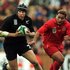 Josh Kronfeld is shadowed by Tonga's Elisi Vunipola during their match in Bristol. The All Blacks won 45-9.
Photo / Getty Images
