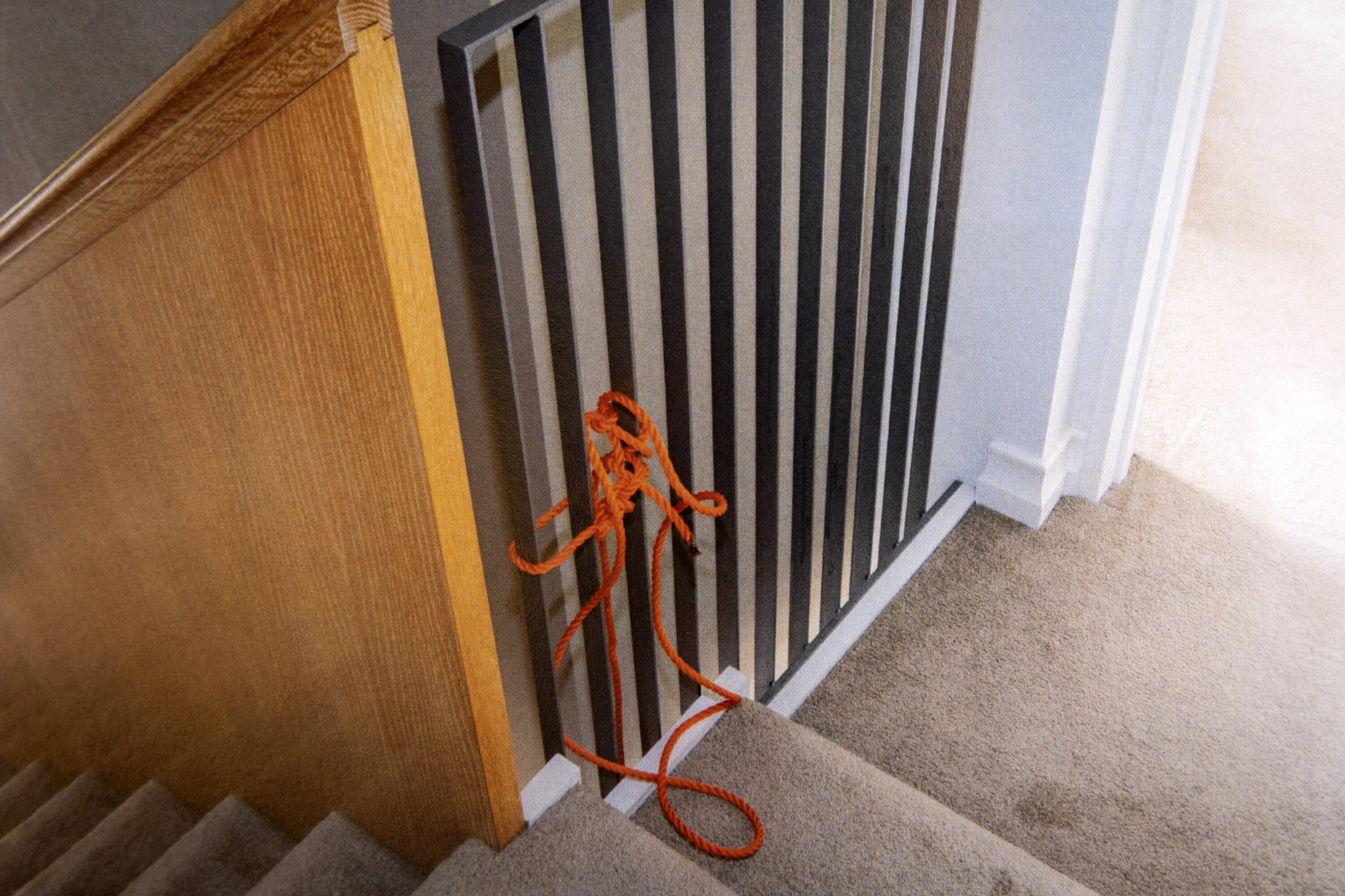 The rope tied to the balustrade at Philip Polkinghorne's home. Police removed it from the house and wrapped it in cardboard for forensic examination, but did not provide it to a rope analyst who appeared as an expert witness for the Crown. Photo / NZ Police