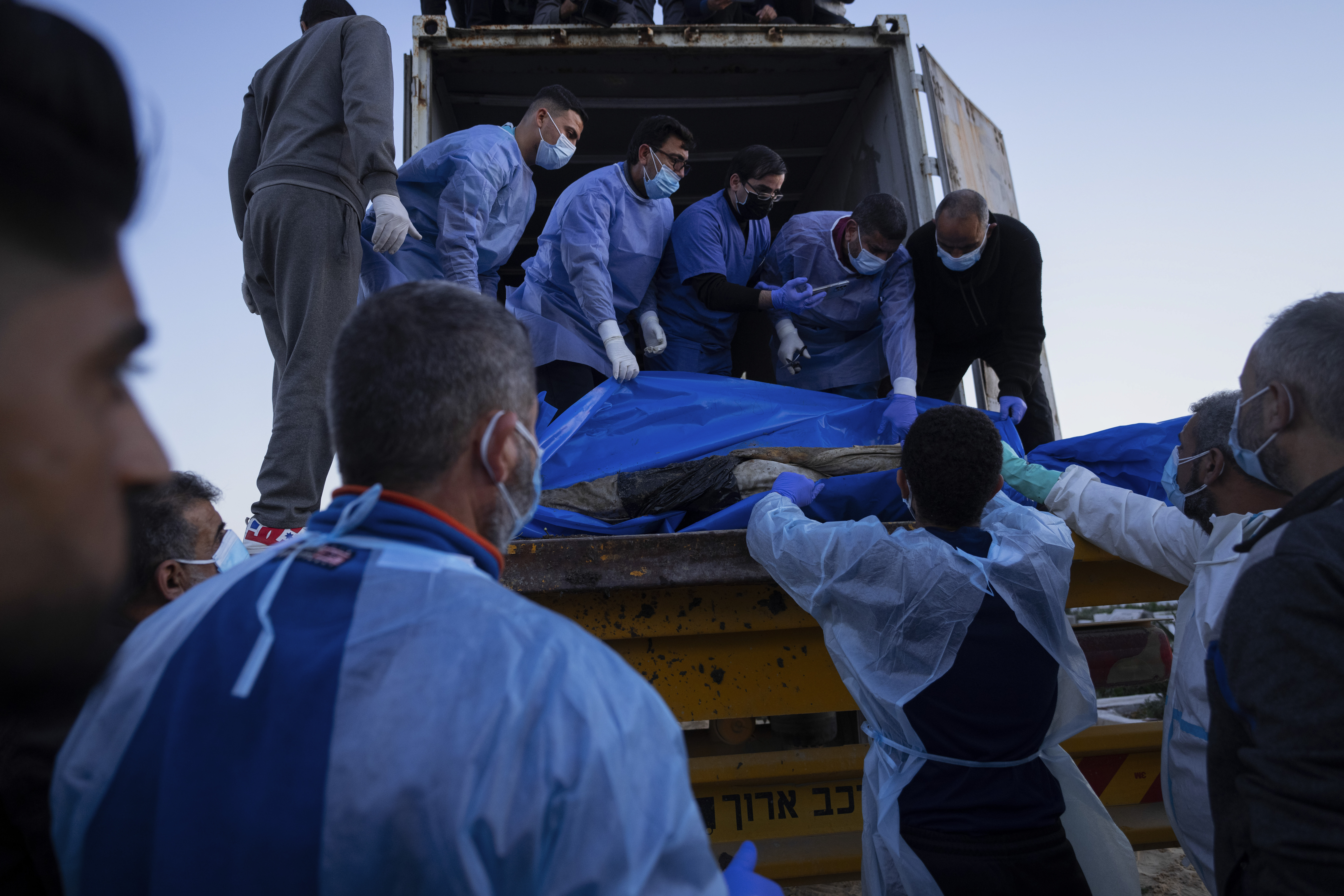 Medics unload the bodies of Palestinians killed in fighting with Israel and turned over by the Israeli military during a mass funeral in Rafah, Gaza Strip. Photo / AP