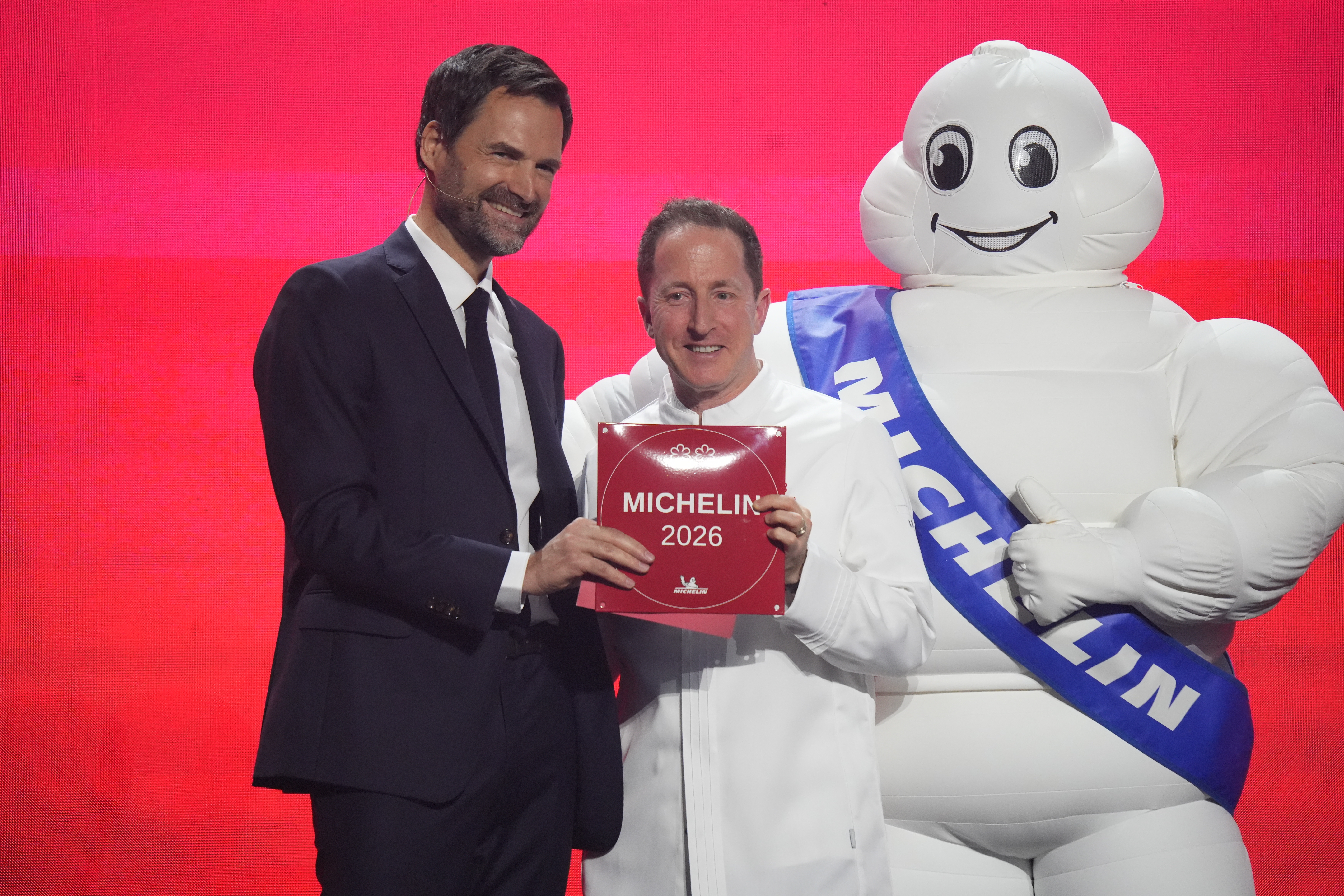 Michelin Guide international director Gwendal Poullenec (left) awards executive chef Paul Froggatt the night's only two-star distinction for Queenstown restaurant Essence. Photo / Alyse Wright