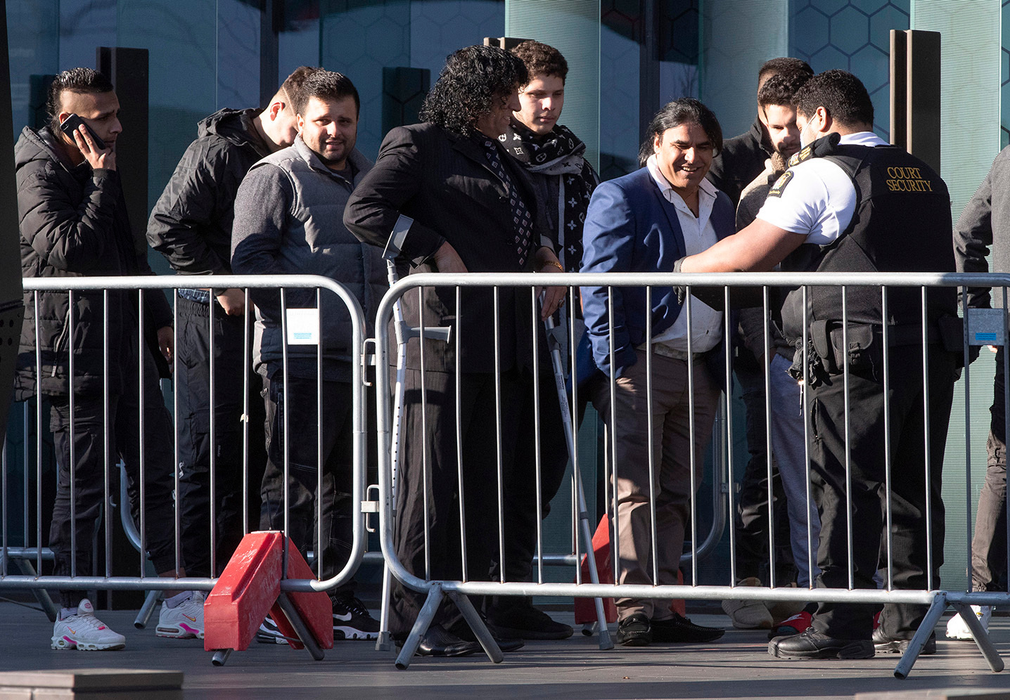 Family and survivors from the March 2019 Christchurch mosque shootings line up to enter Christchurch High Court. Photo / AP