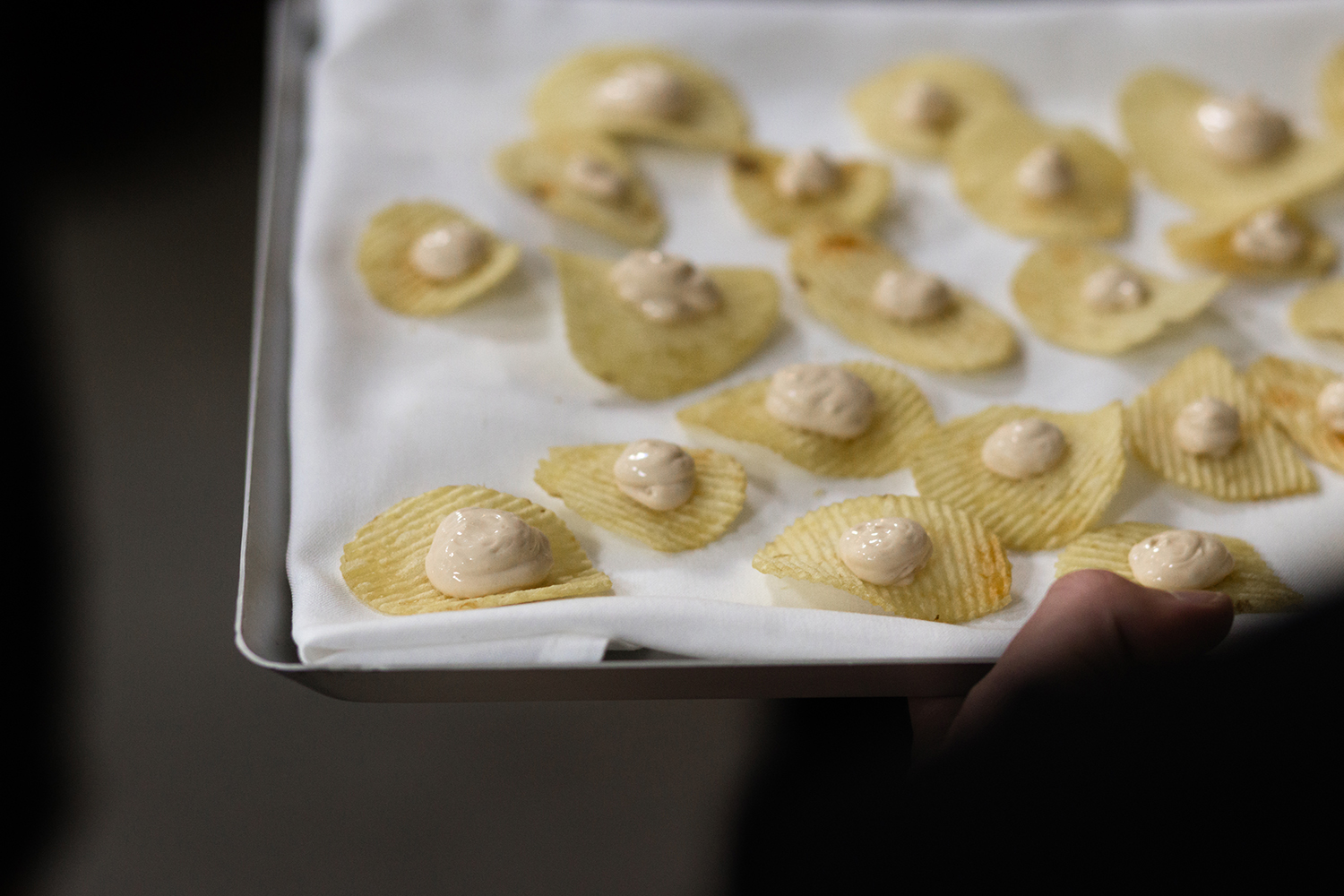 For an inventive appetiser, classic Kiwi onion dip was piped onto potato crisps. Photo / Sara Tansy