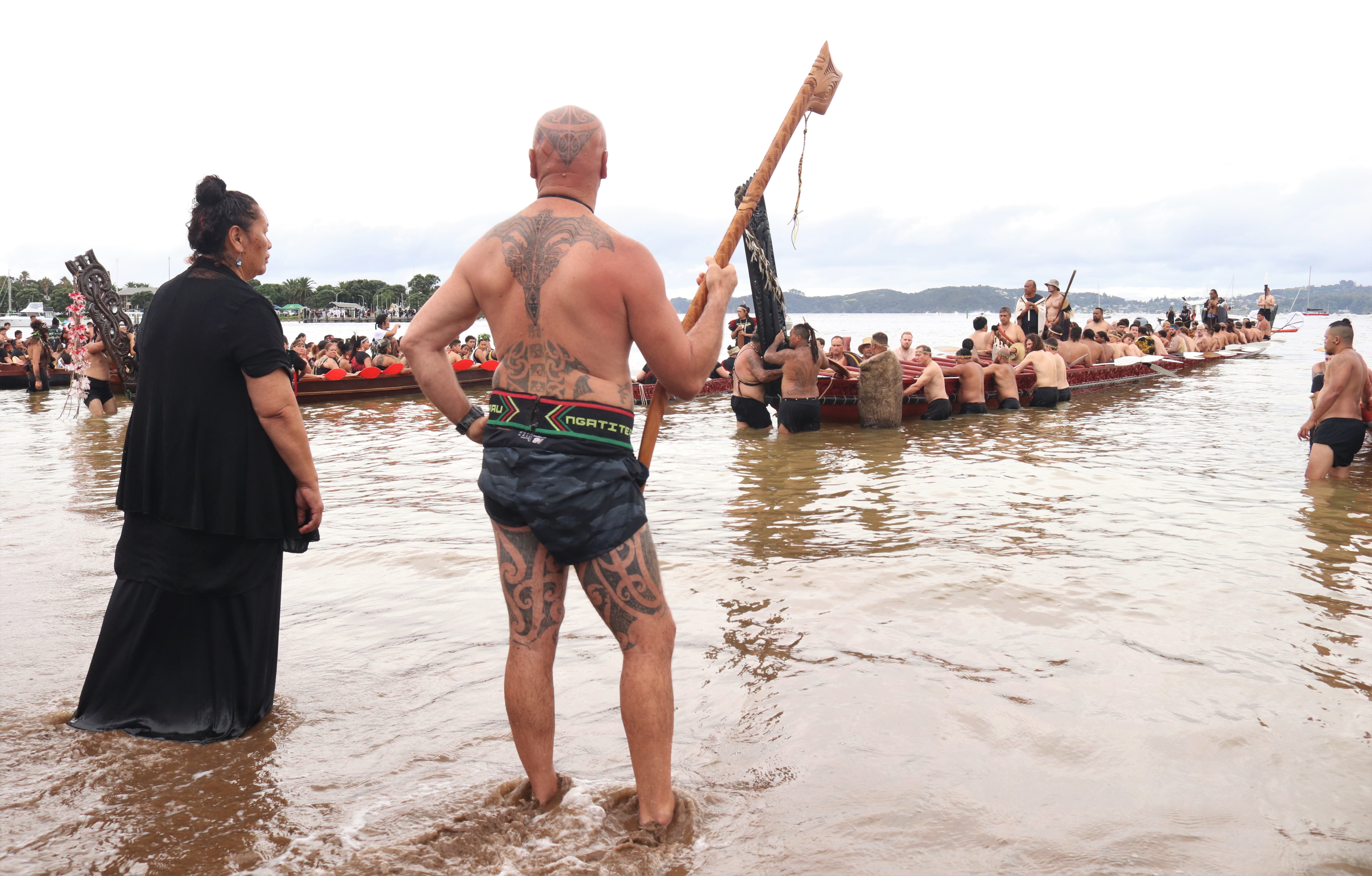 Wiremu Keretene (Ngāti Hine) greets the great waka Ngātokimatawhaorua at Tii Beach. Photo / Peter de Graaf