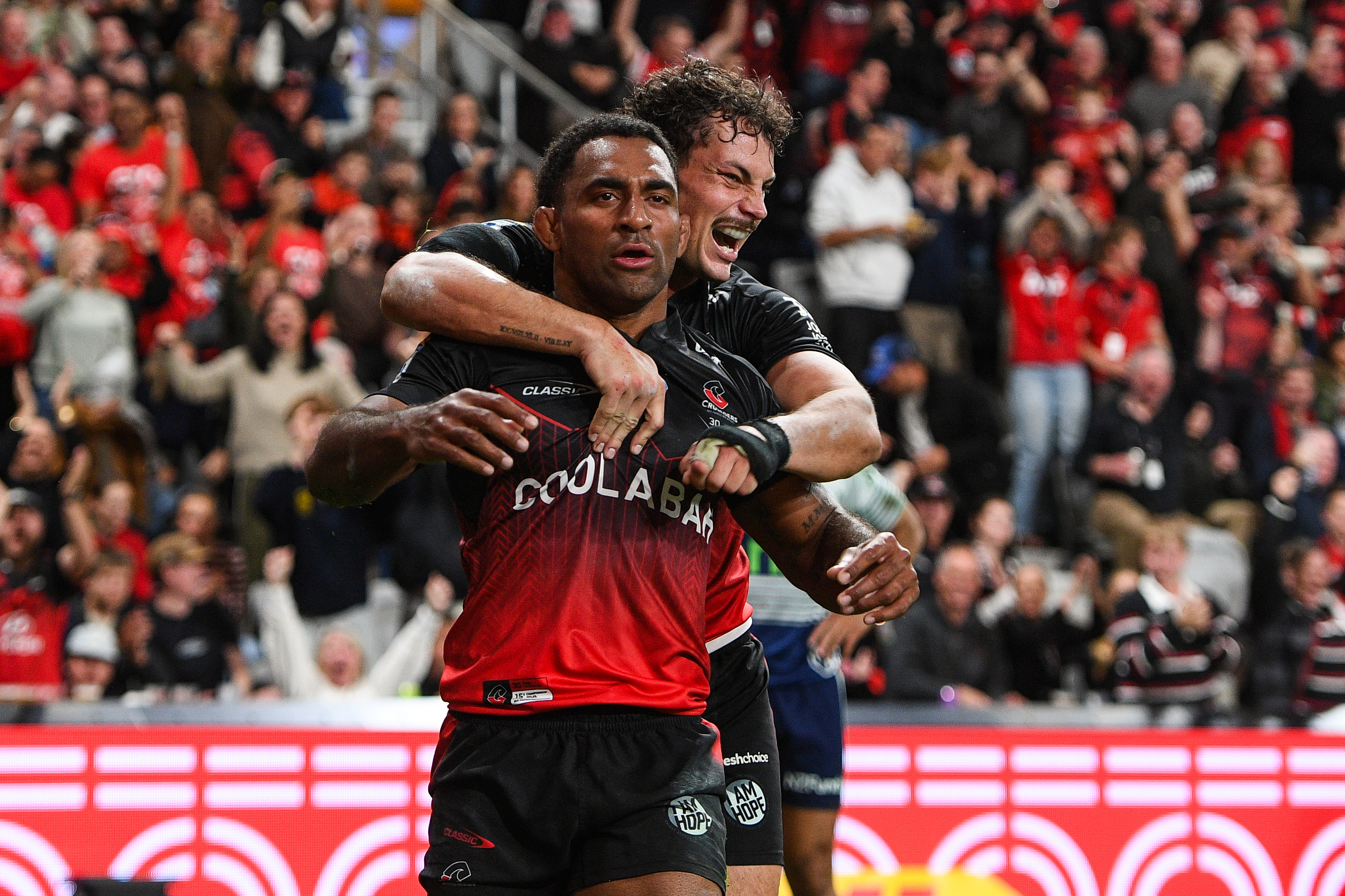 Macca Springer and Sevu Reece celebrate a Crusaders try against the Blues. Photo / Photosport