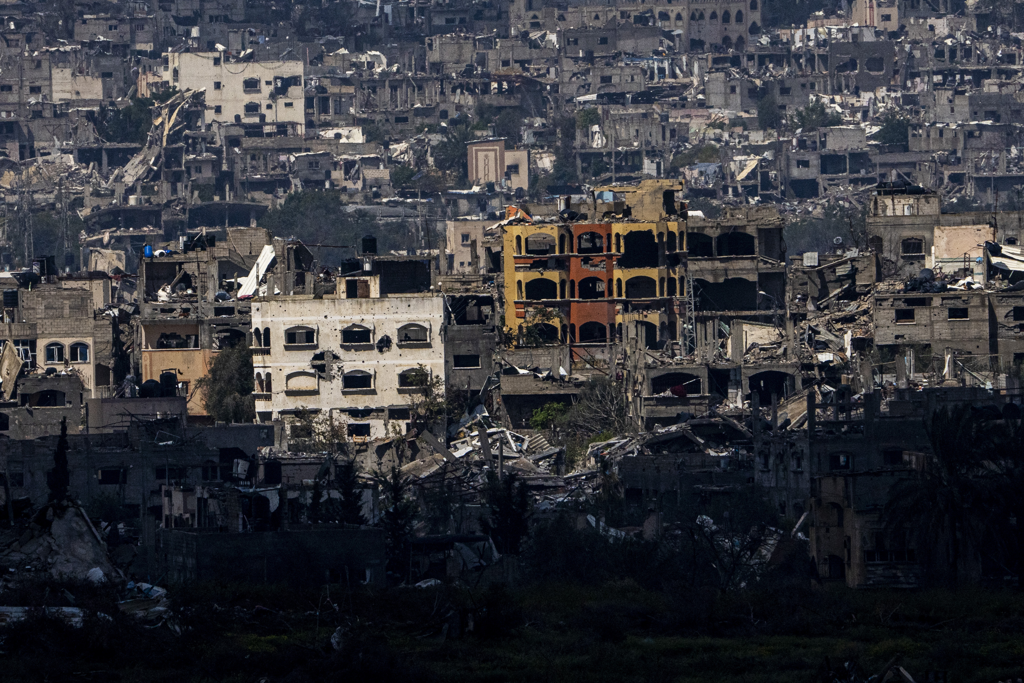 Destroyed buildings stand inside the Gaza Strip, as seen from southern Israel. Photo / AP