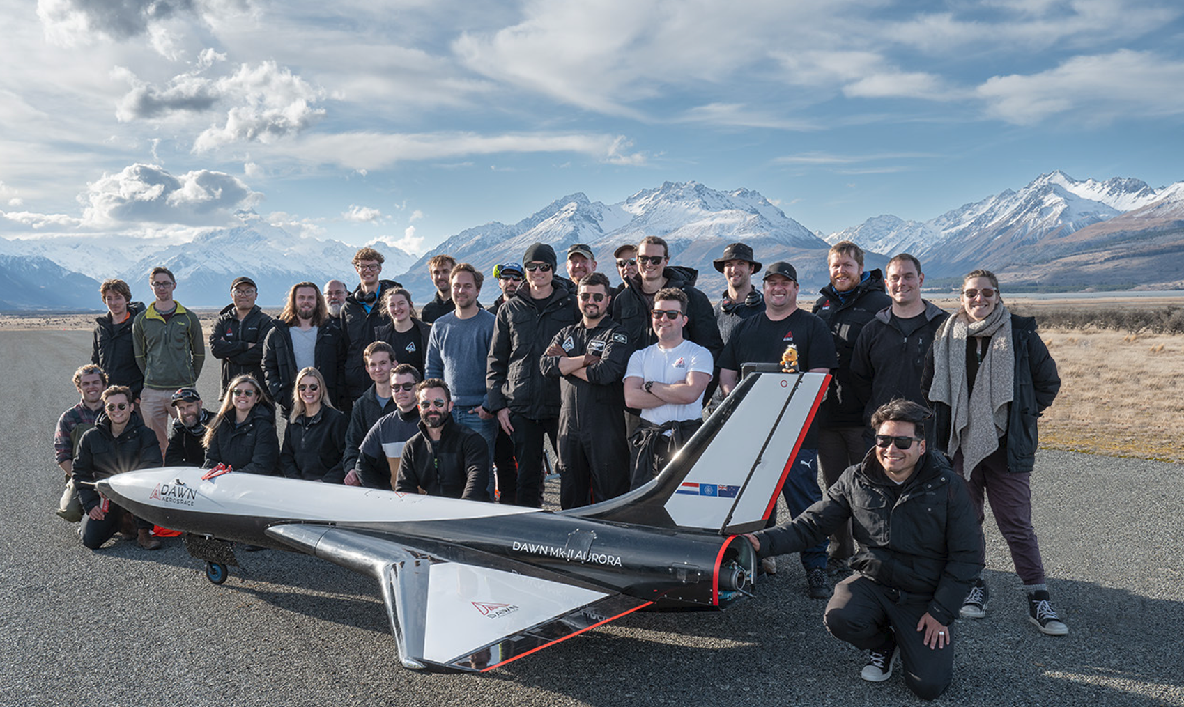 Members of the Dawn Aerospace team with the Mk II Aurora at Glentanner Aerodrome near the base of Aoraki Mt Cook.