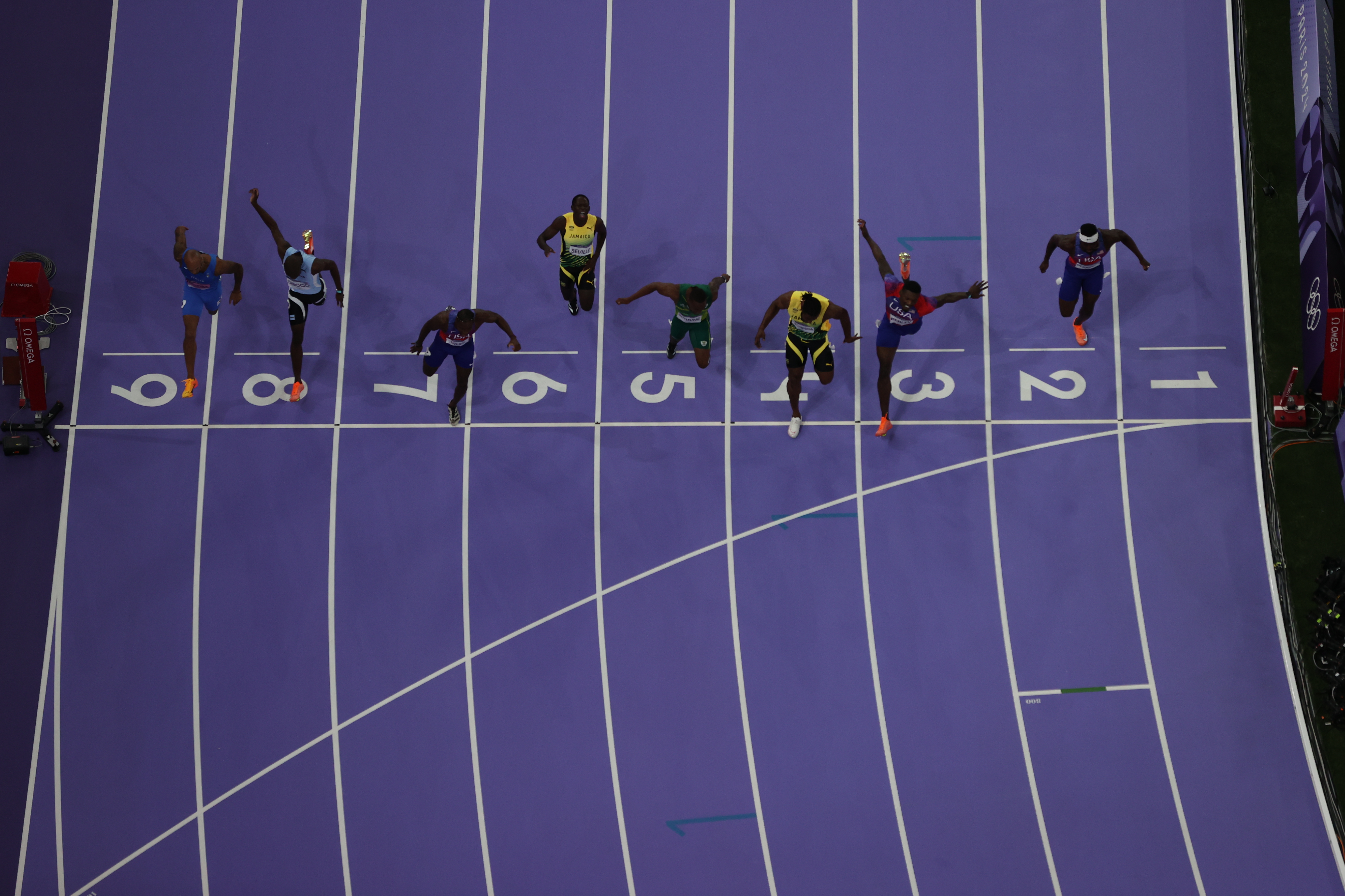 Athletes cross the finish line during the Men's 100m Final. Photo / Getty Images