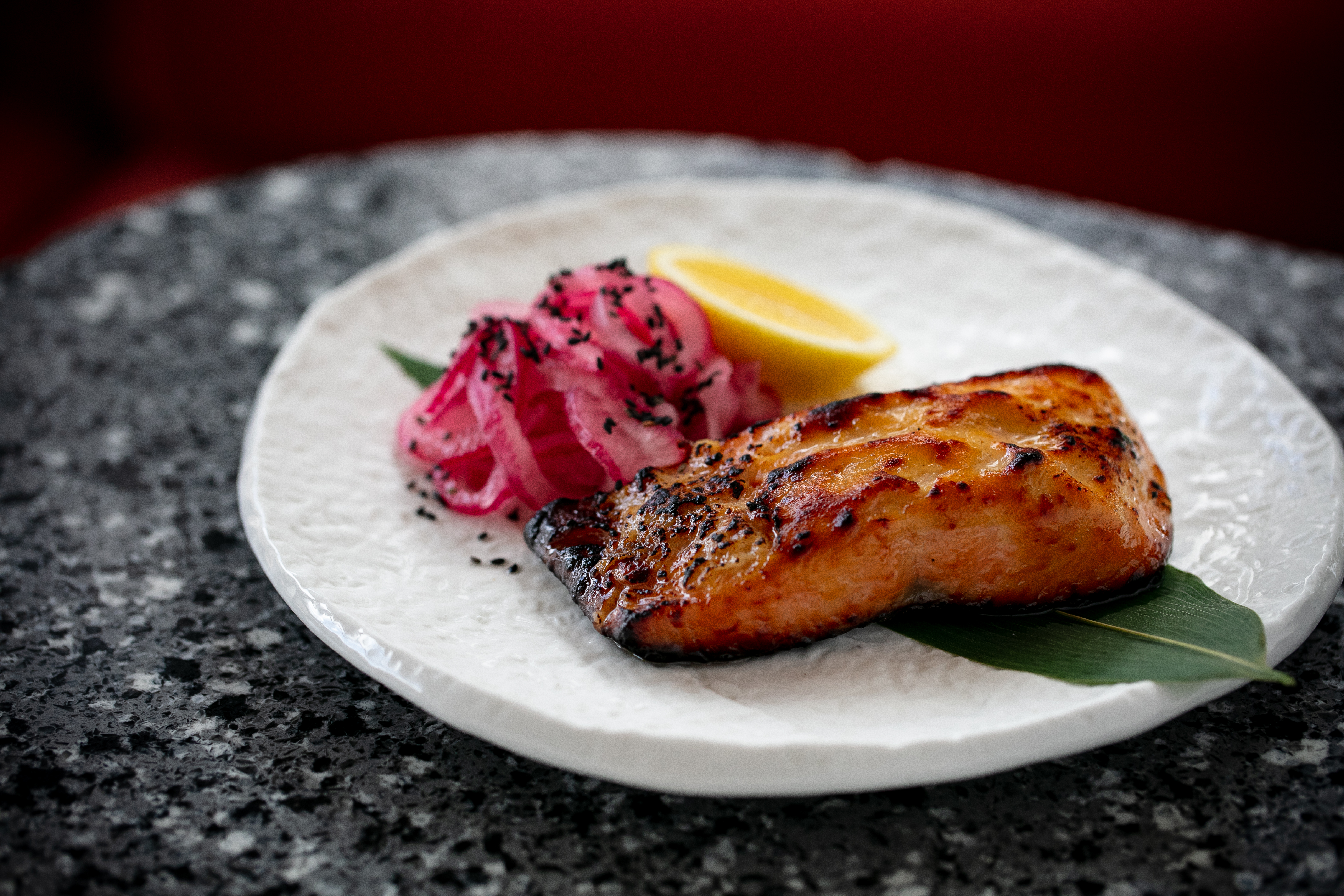 The miso-marinated salmon yakitori is paired with simple garnishings. Photo / Babiche Martens