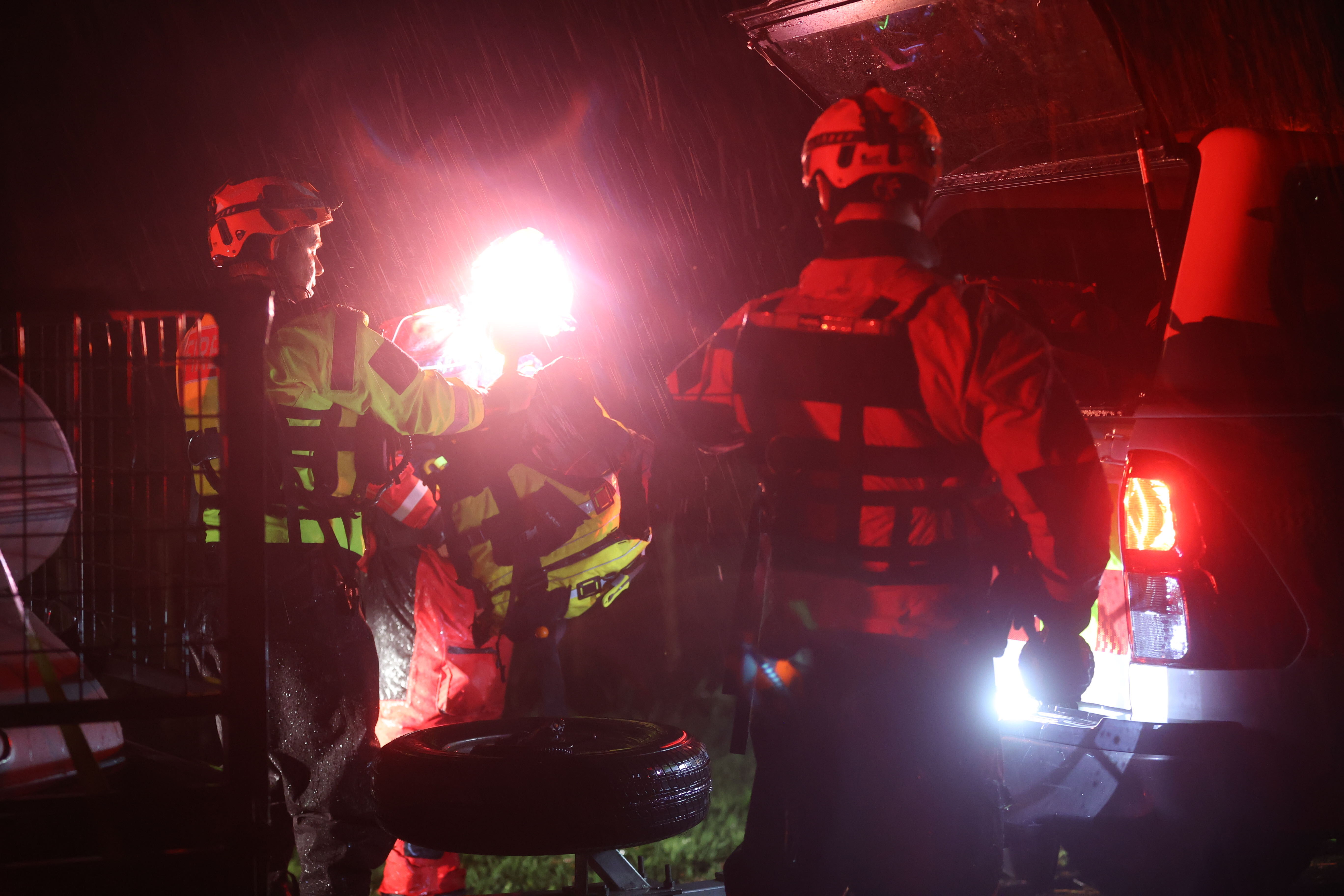 Fire crews on the scene rescuing multiple families from flood-stricken Dale Road, Ramarama. Photo / George Heard