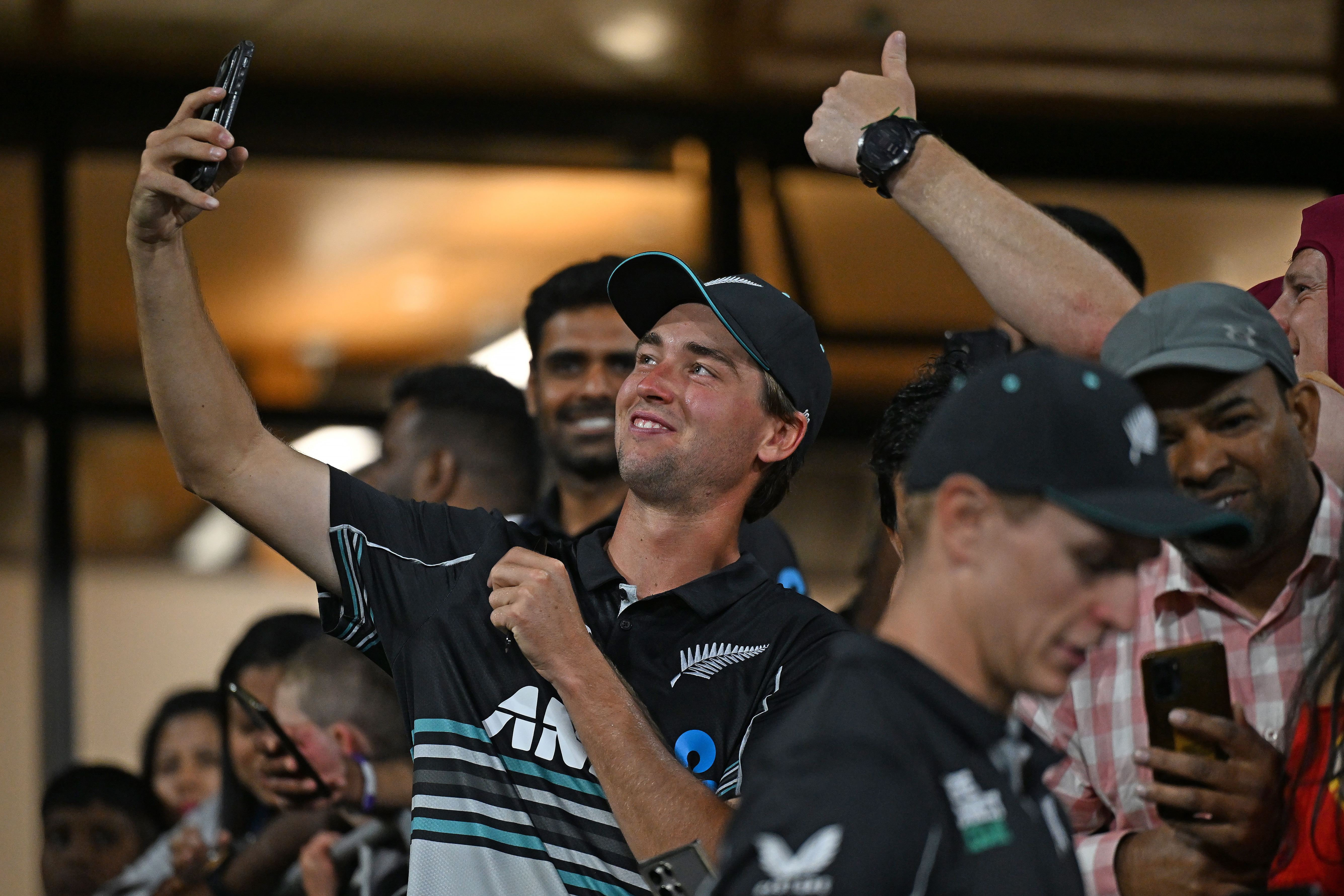 Zak Foulkes poses for photos with fans following the first T20. Photo / Photosport