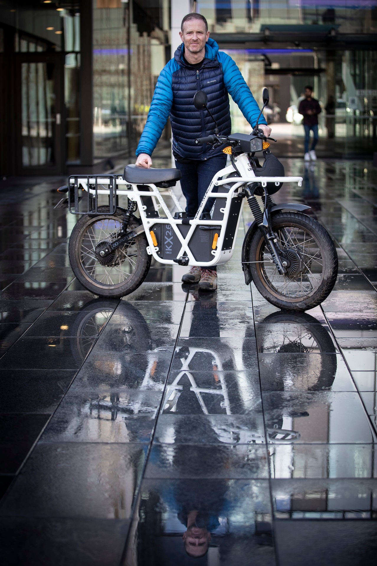 UBCO CEO Timothy Allan with the 2021 (fifth-generation) model of his company's 2X2 ADV (from $7999), a lightweight (70kg) electric motorcycle with a road-registerable top speed of 50km/h, a hot-swappable battery and a range of up to 120km on a single 6-hour charge. Photo / Jason Oxenham