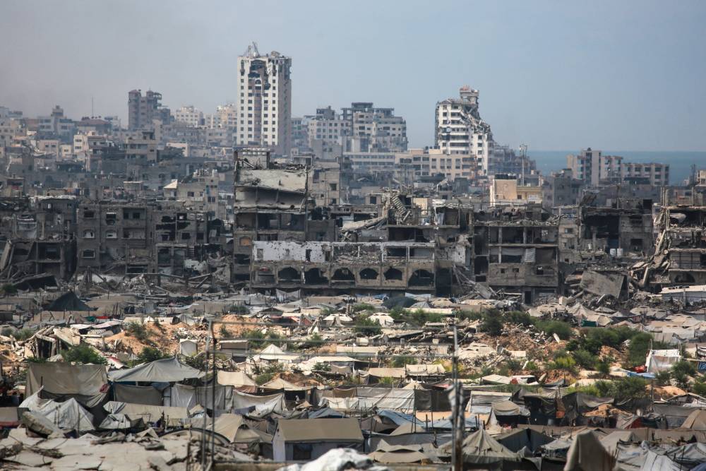 Buildings destroyed in Israeli strikes surround makeshift shelters for displaced Palestinians in Gaza City. Photo / Bashar Taleb, AFP