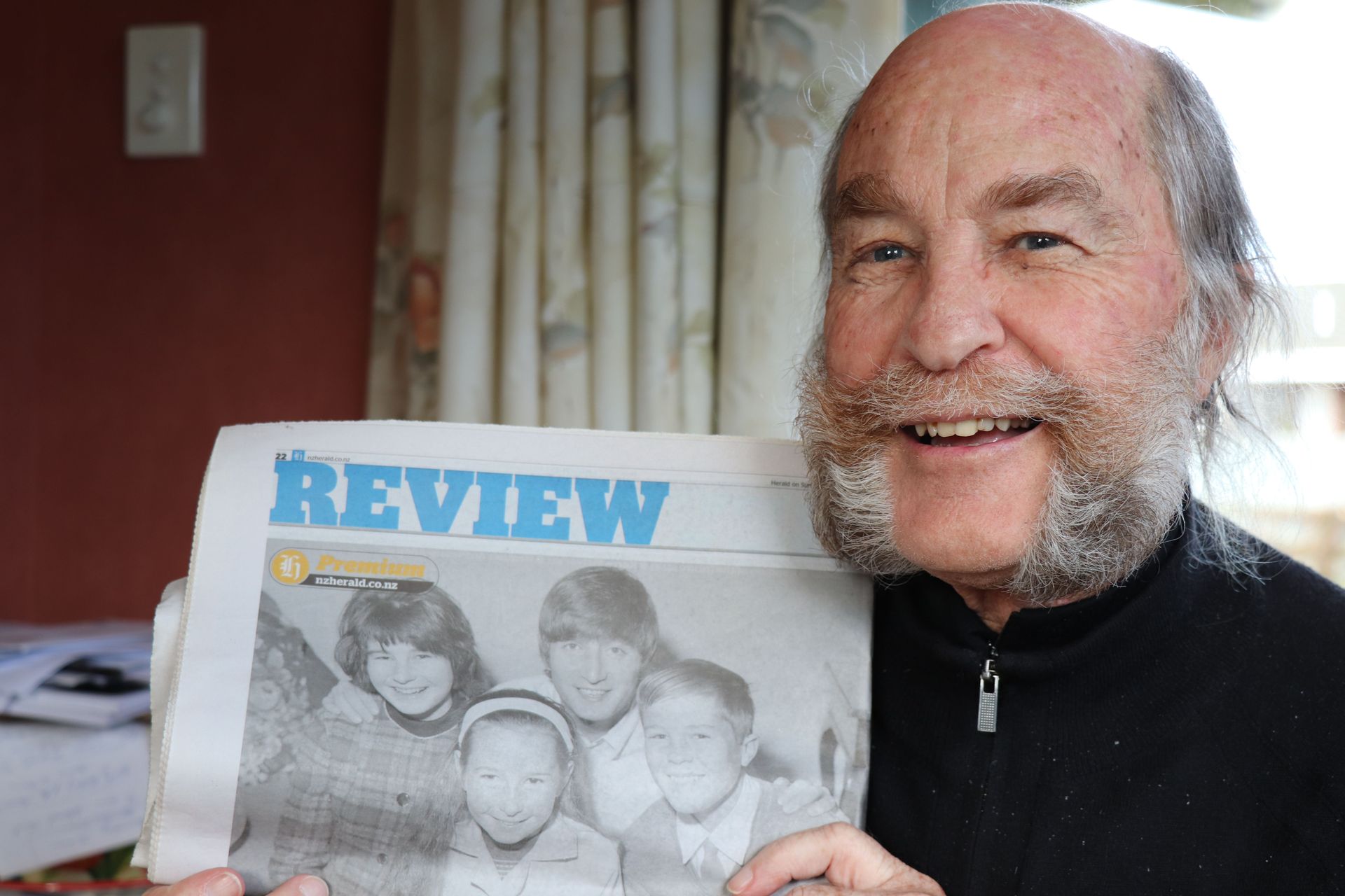 Levin man Mark Parker with a photo of him, his sisters and their cousin John Lennon, taken during the 1964 tour. Photo / NZME